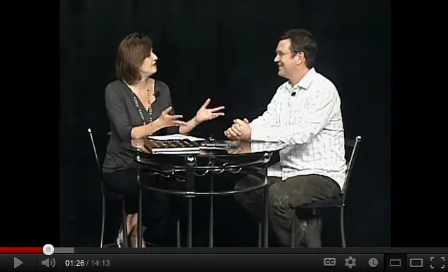 Scott Indermaur during a QATV television interview discussing the REVEALED documentary storytelling project.