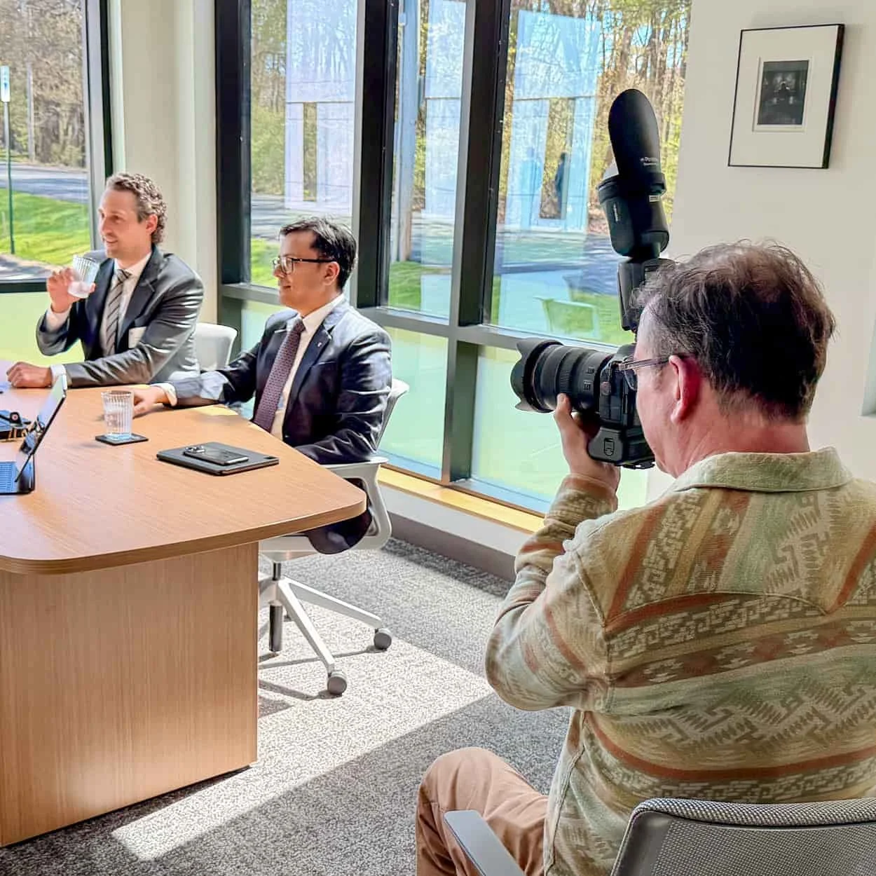 Corporate photographer creating executive portraits during a business meeting in a Boston-area office.