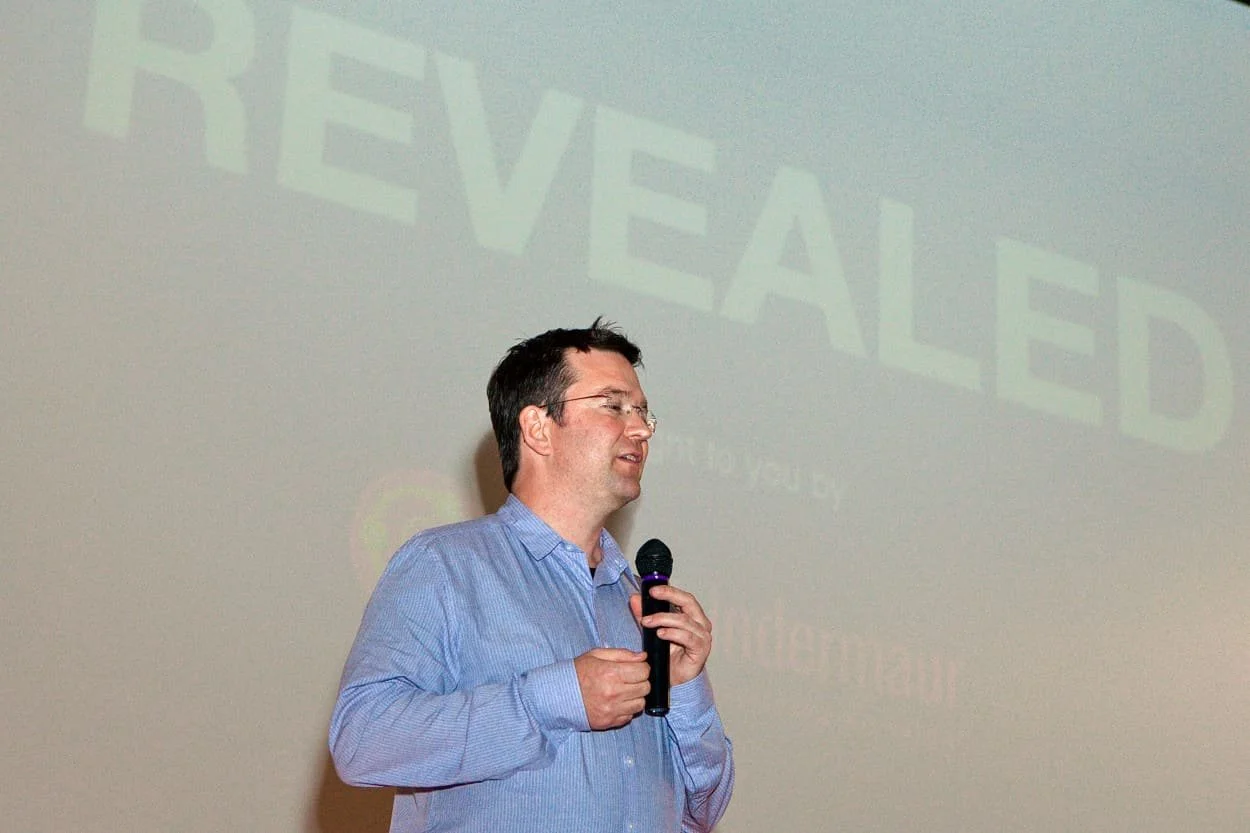 Scott Indermaur presenting the REVEALED documentary project during a public speaking engagement.