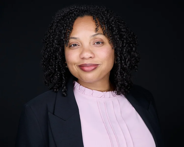 Business headshot of a woman with natural expression at Tucson studio