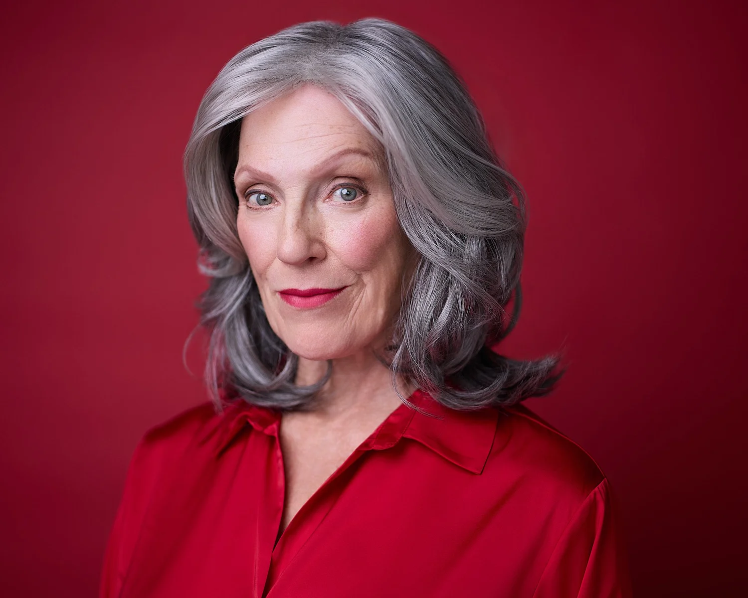 Professional headshot of a woman demonstrating confident expression coaching at Carlos Chavez Photography studio in Tucson