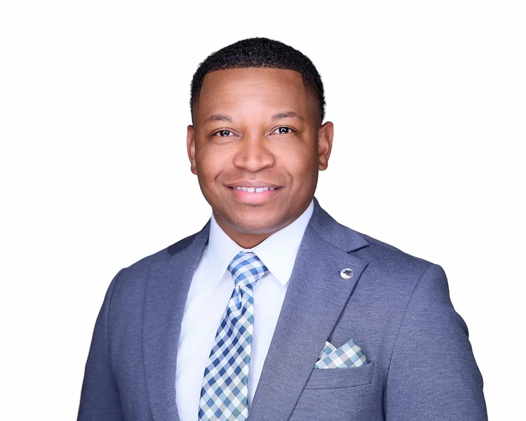Professional headshot of a man in a grey suit by Carlos Chavez Photography