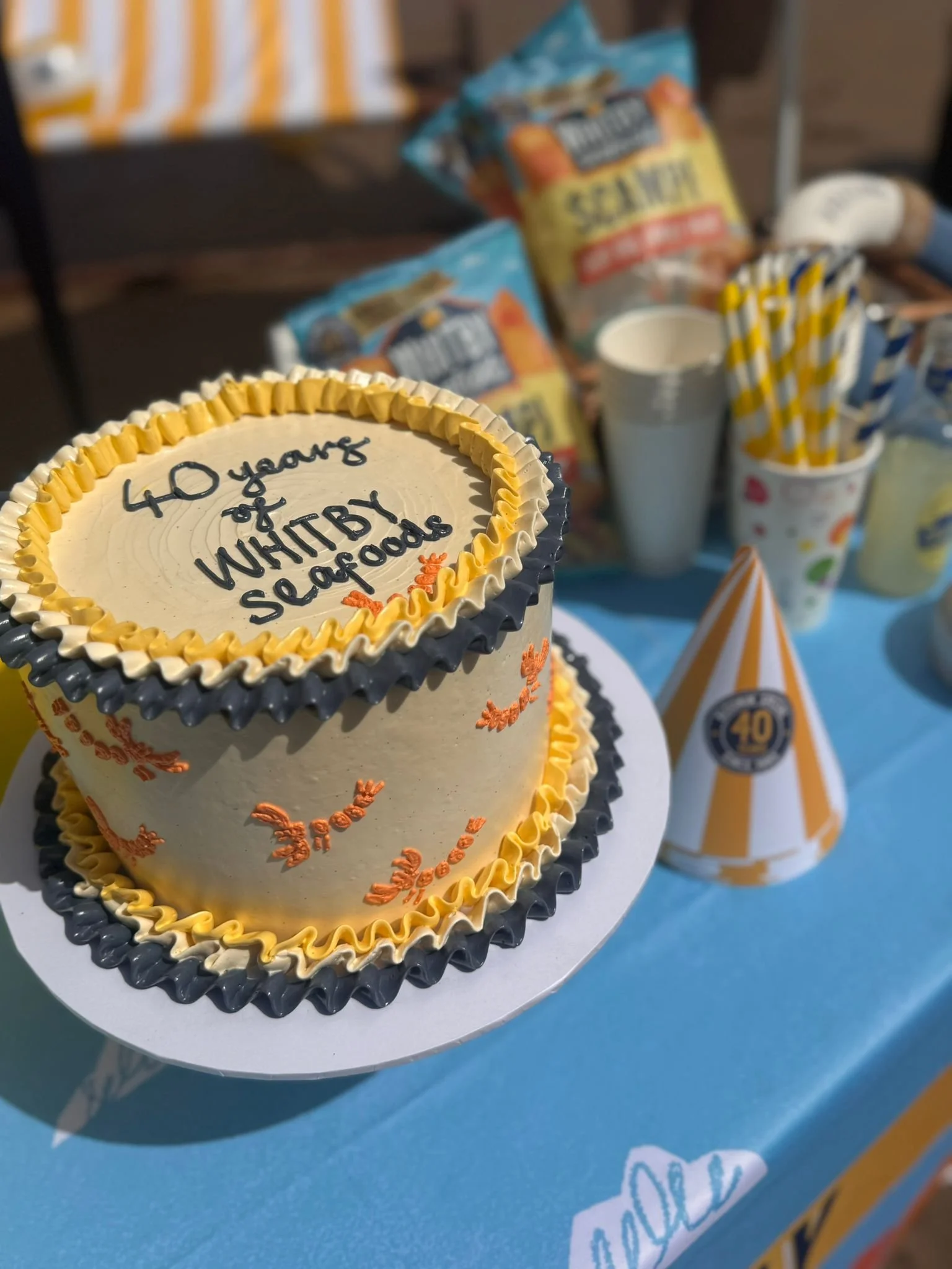 Whitby Seafoods celebrating 40 delicious years with a delicious birthday cake on the beach during a team celebration.JPG
