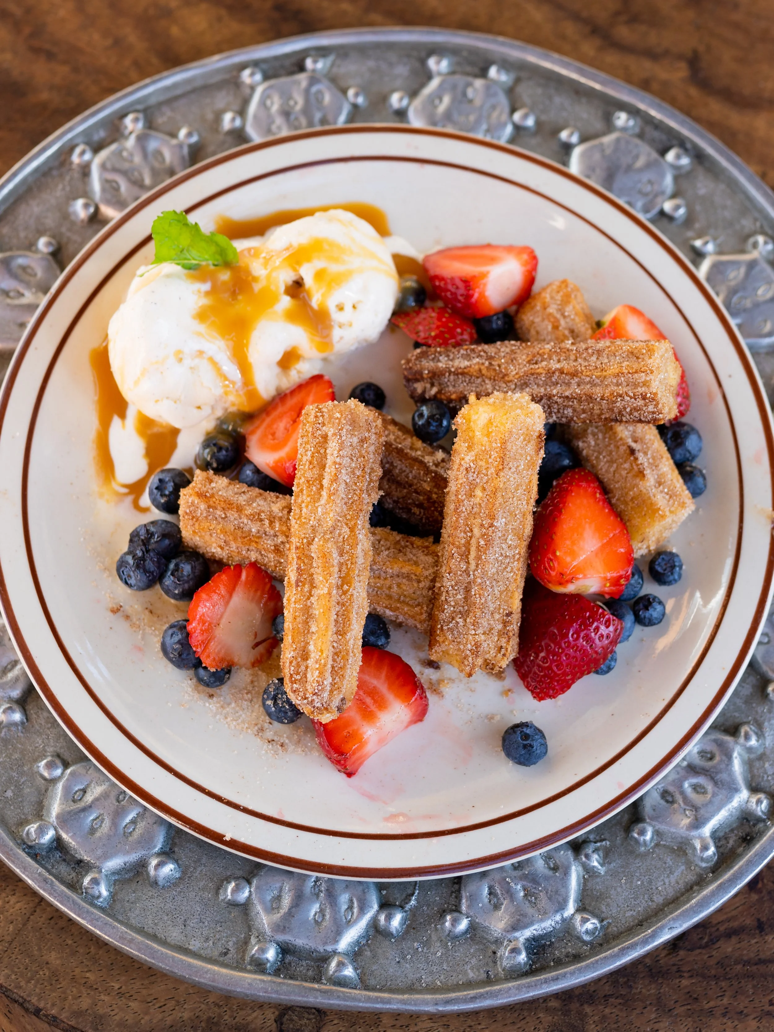 Mexican dessert menu Temecula, Freshly fried churros dusted with cinnamon sugar, served warm with whipped cream and fresh berries.