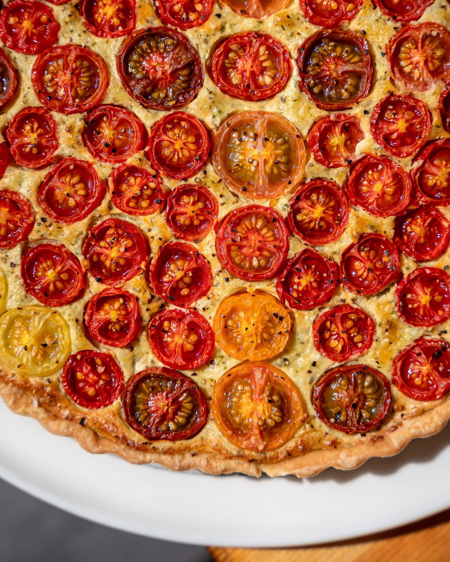 It's BACK. Tomato season is in full effect and we're so excited to be able to bake our beloved Tomato Tarts once again!
Heirloom tomatoes, parmesan, roasted garlic, cream cheese, and basil on a delicious savory crust!

Come get yourself some slices w