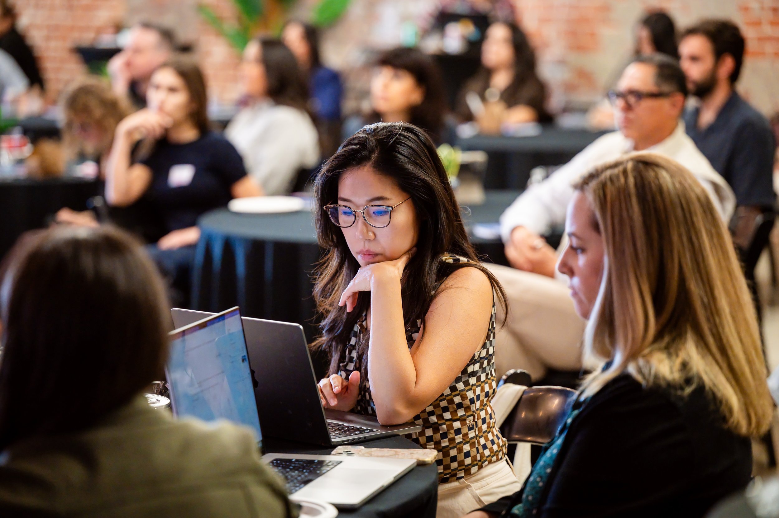 Journalists in the audience listen during an OpenAI Forum panel on AI in local news moderated by Olivia Smith