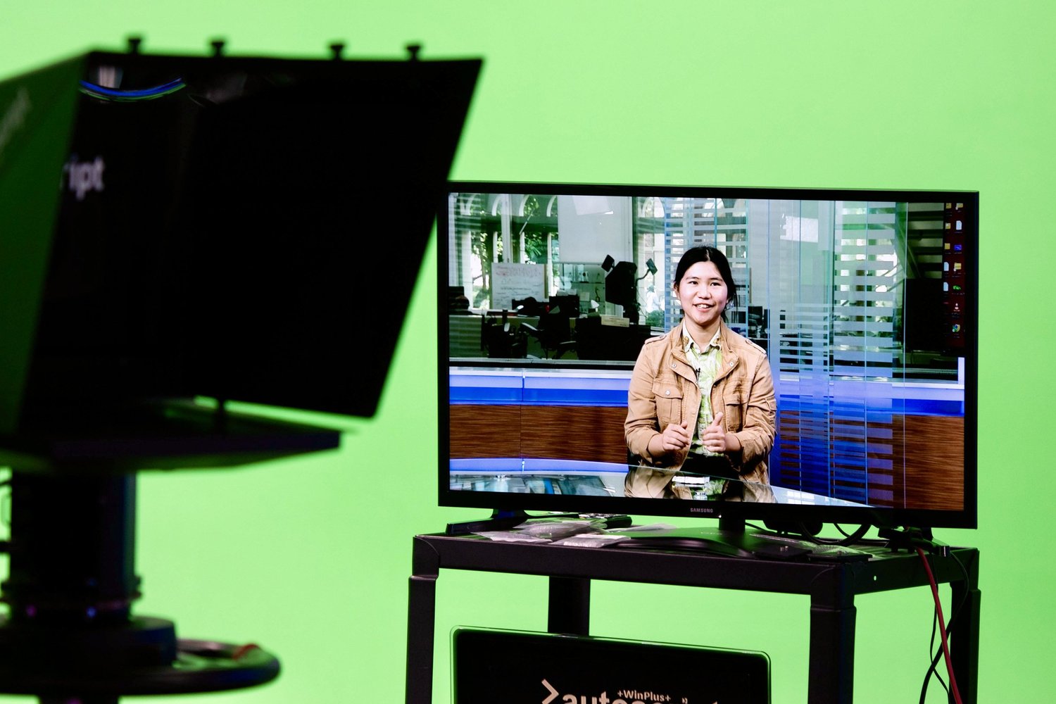 On-camera coaching session in a Los Angeles studio with a client on the monitor in front of a green screen