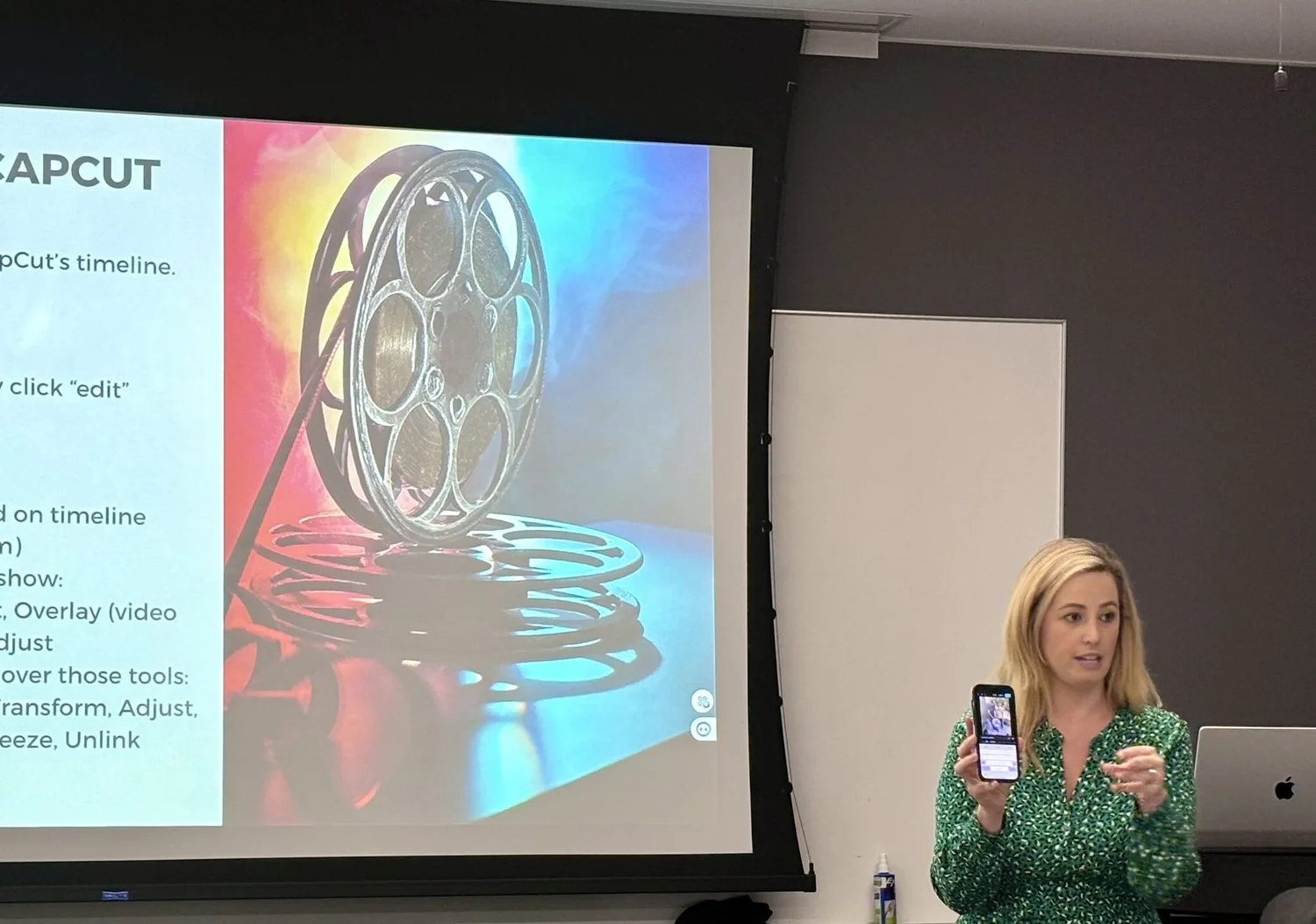 Olivia Smith teaching a mobile video editing workshop with a phone in hand