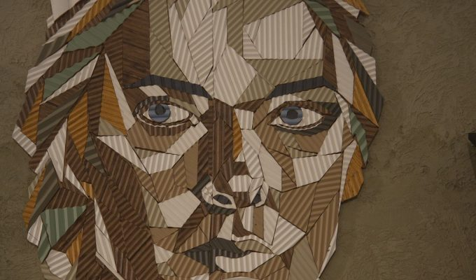 A geometric portrait made from textured decorative materials