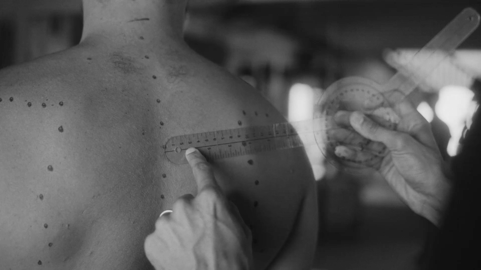 CHEK Functional Health Coach measuring scapula distance with a goniometer and spinal curvature with anatomical markings to create a custom corrective exercise & rehabilitation program delivered through a holistic methodology 