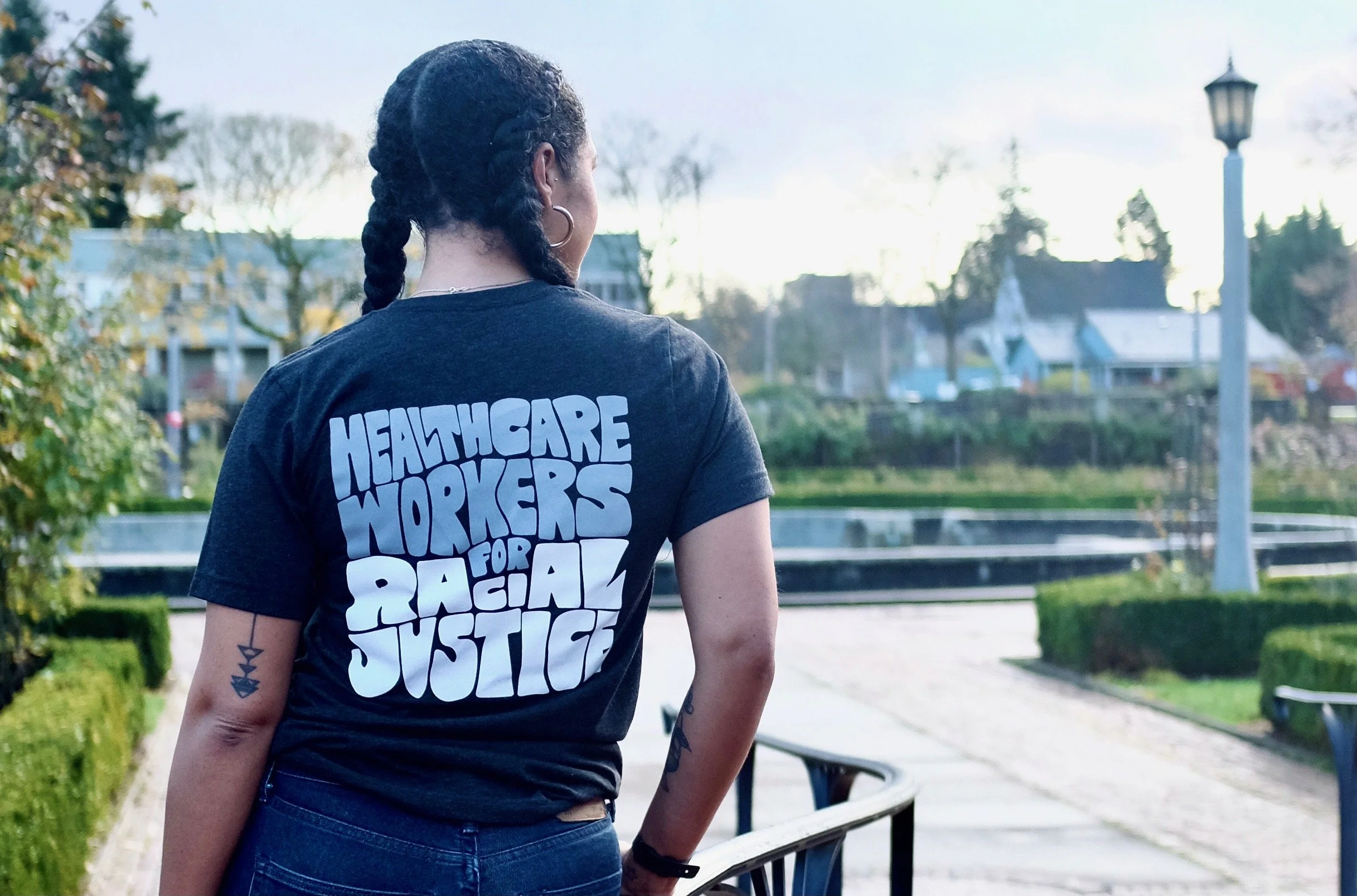 woman wearing tshirt with custom type healthcare workers for racial justice