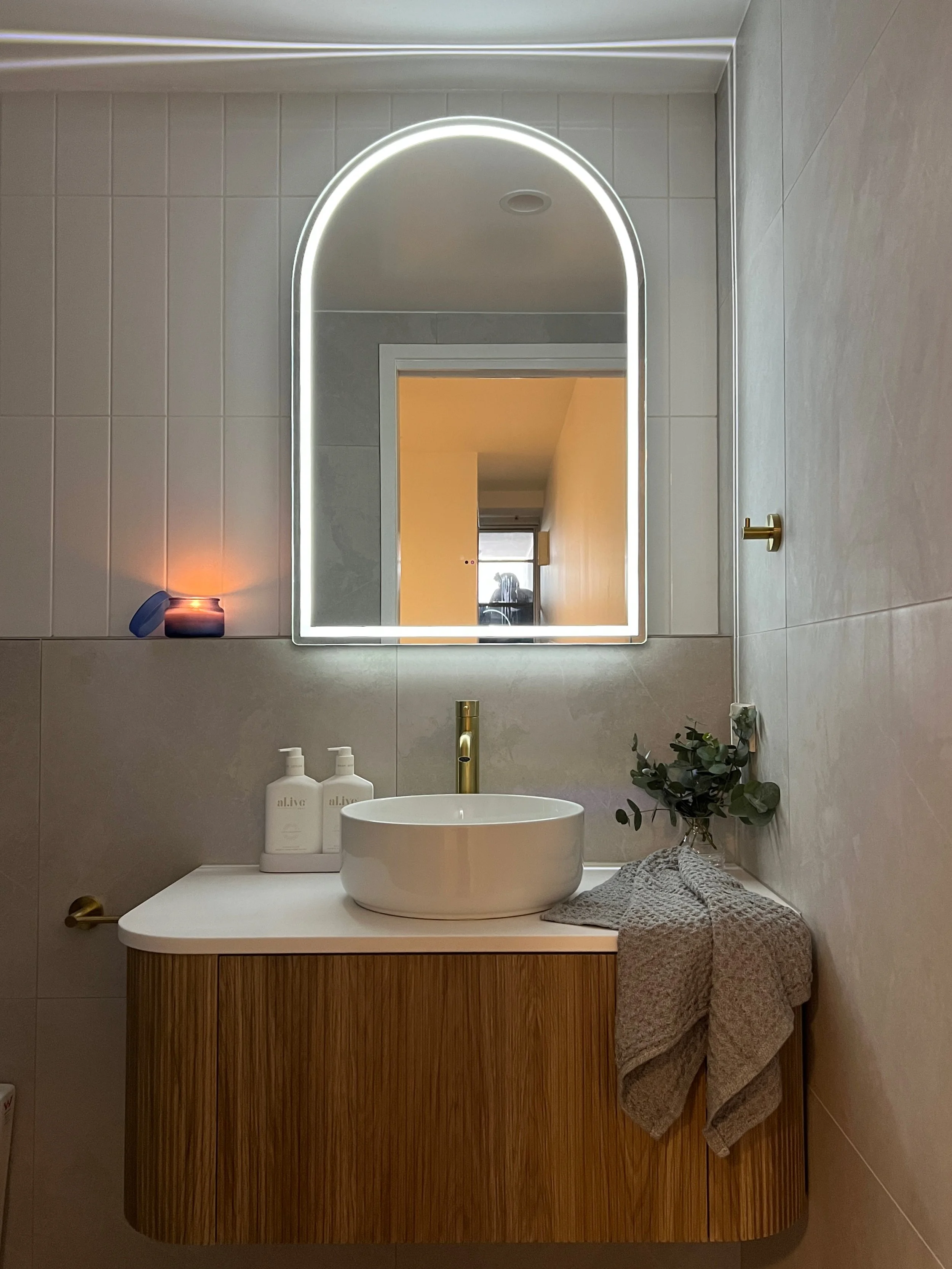 Ensuite with feature LED arched mirror at Ann Street, Fortitude Valley
