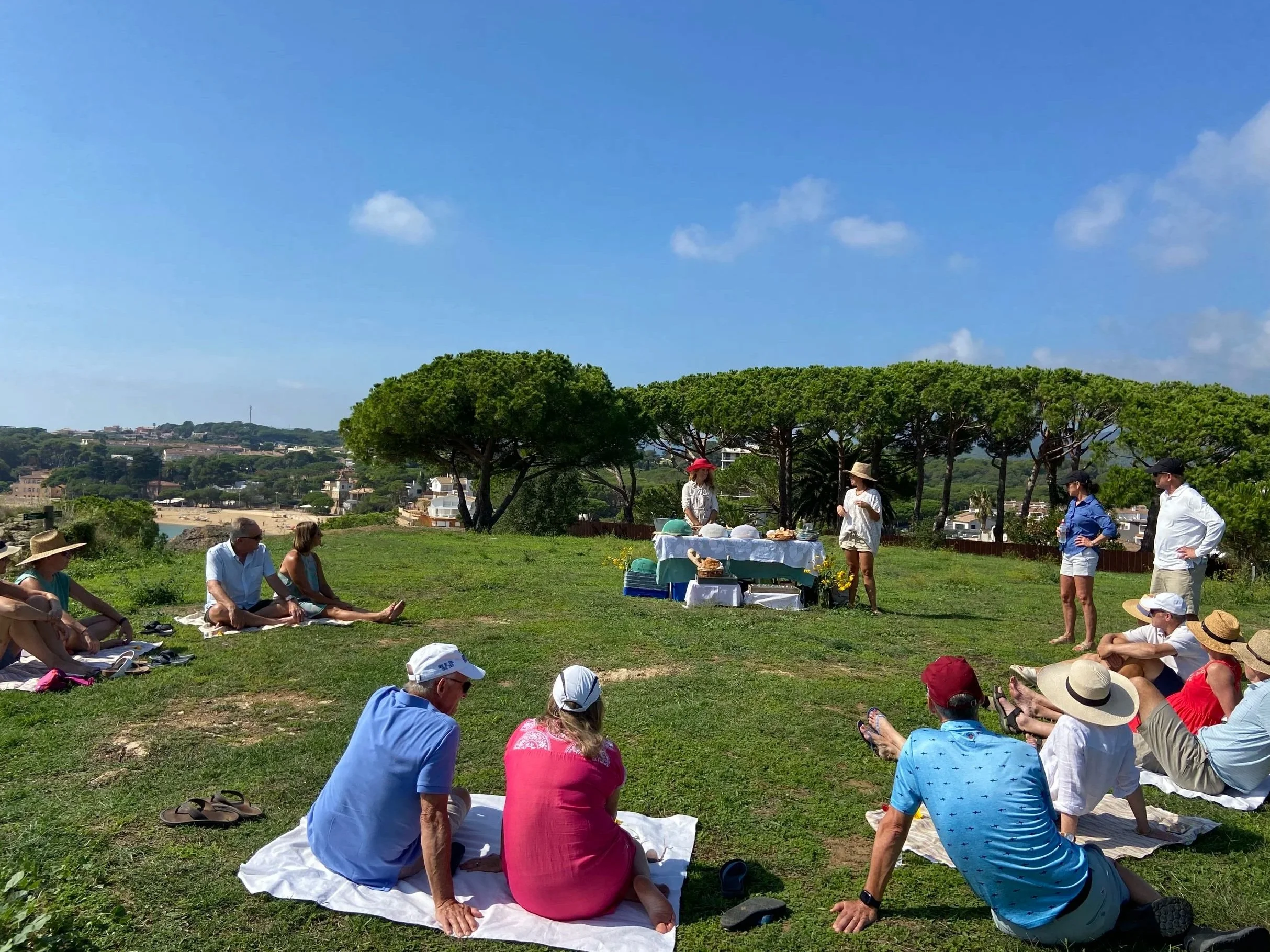 Guests enjoying a Mediterranean picnic in Costa Brava with Caliu Cultural, featuring local food, seasonal ingredients, and outdoor cultural experiences.