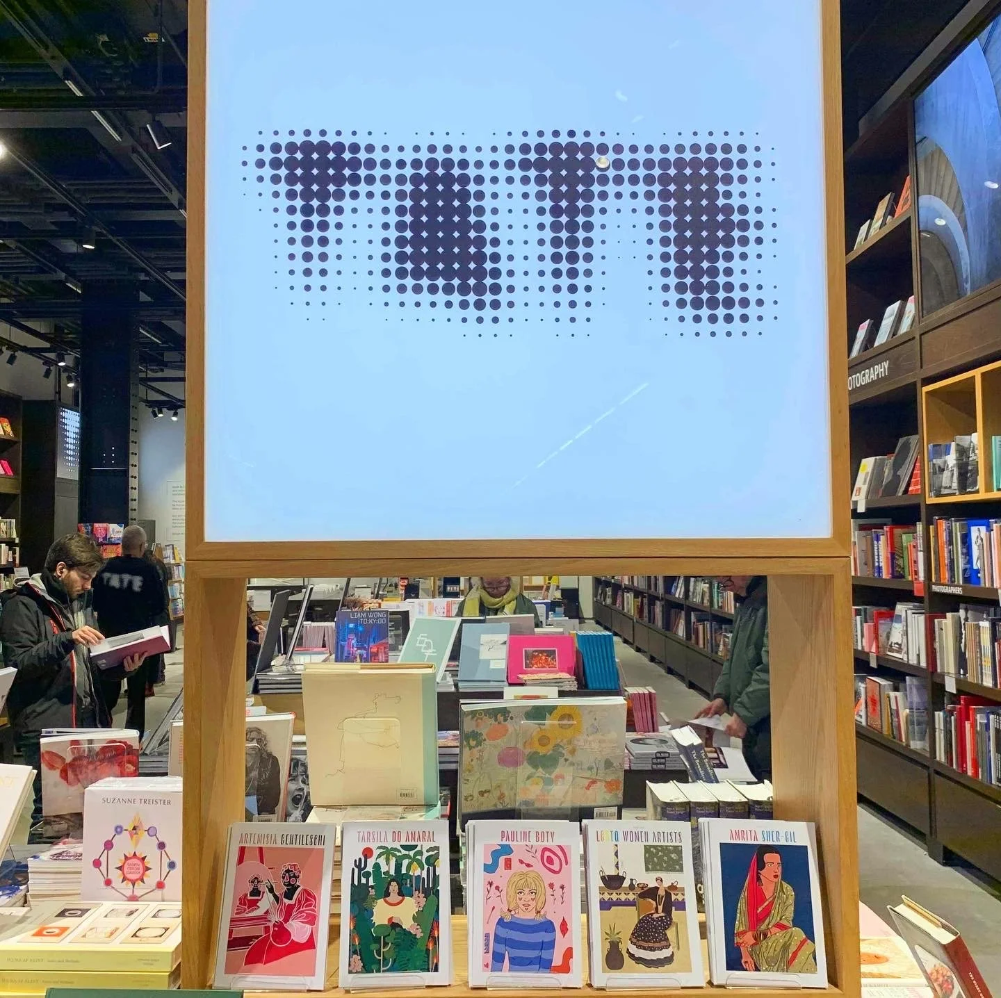 photo of zines below a sign that says 'Tate'