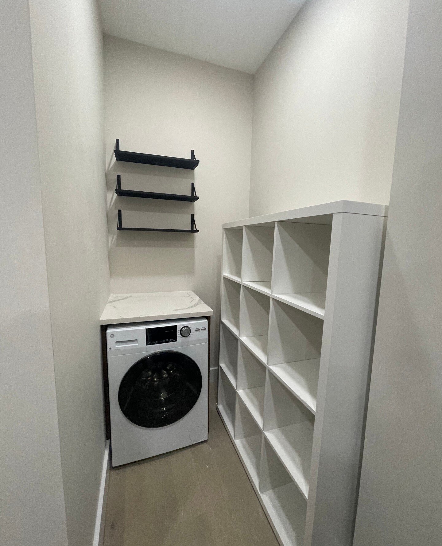 In Manhattan, every inch counts. Taking an unused shaftway and turning it into a storage area with built in shelving as well as a combo washer dryer.