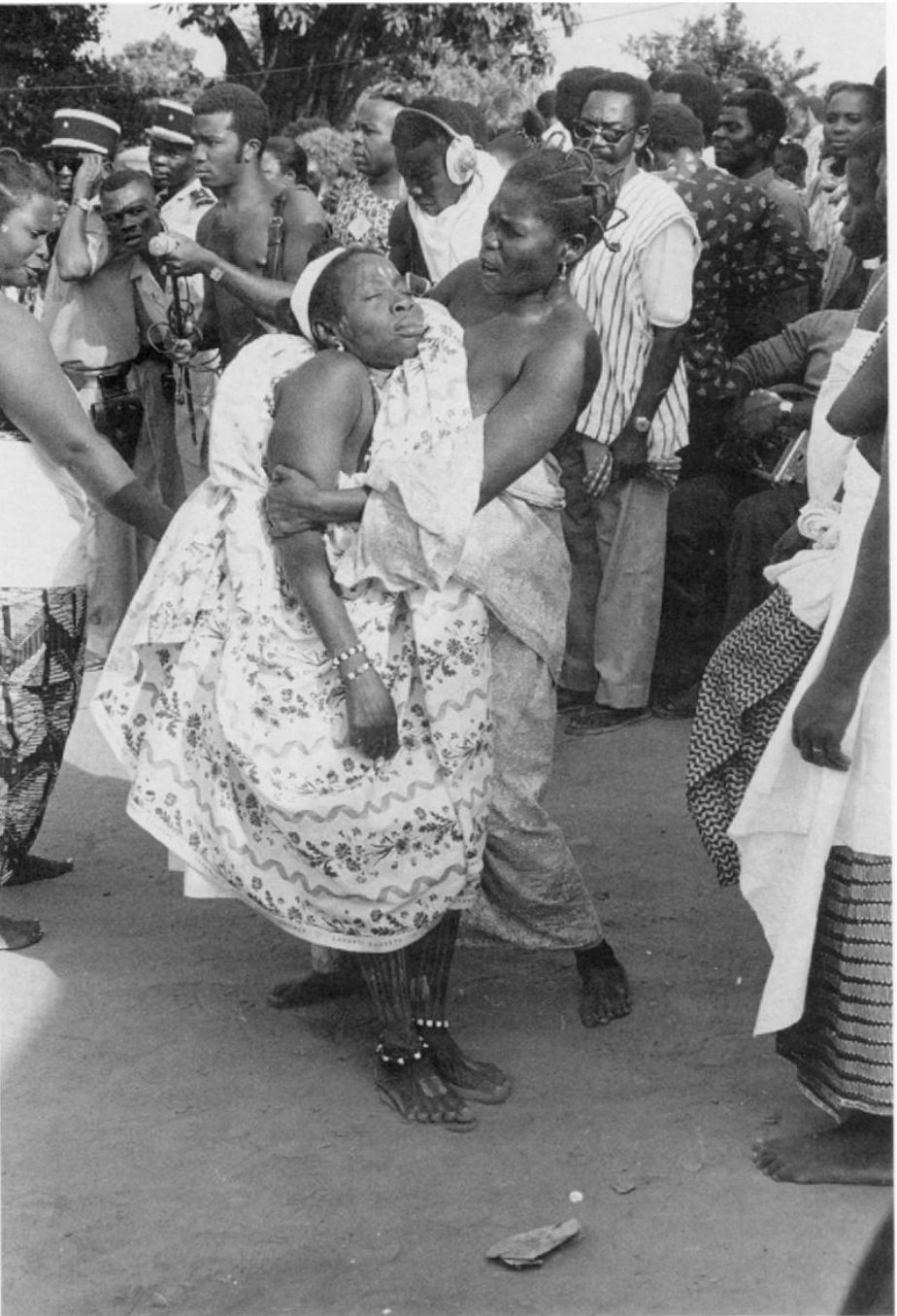   A Mami Wata medium going into trance loses consciousness and is caught by an assistant. Togo, Mina, 1975. Photo by Henry J. Drewal  
