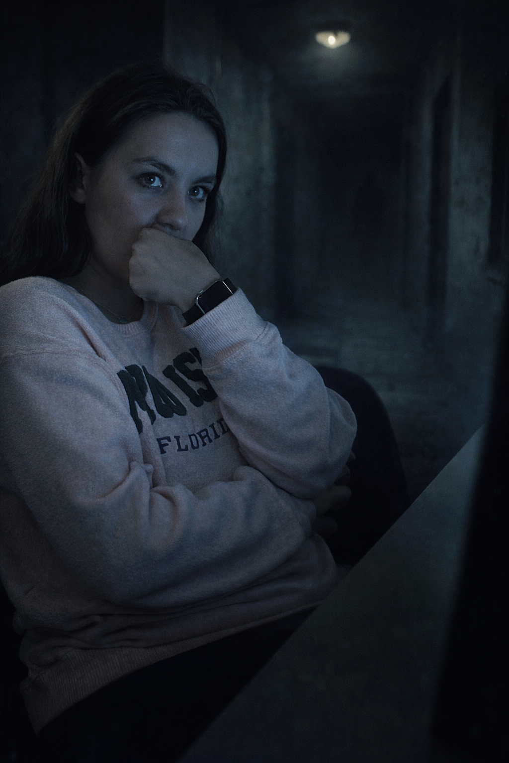 Use this image as the primary facial reference. Preserve the woman’s exact facial features, identity, skin tone, bone structure, hairstyle, body proportions, and recognizable expression. Do not alter her face in any way.

Maintain her seated posture 