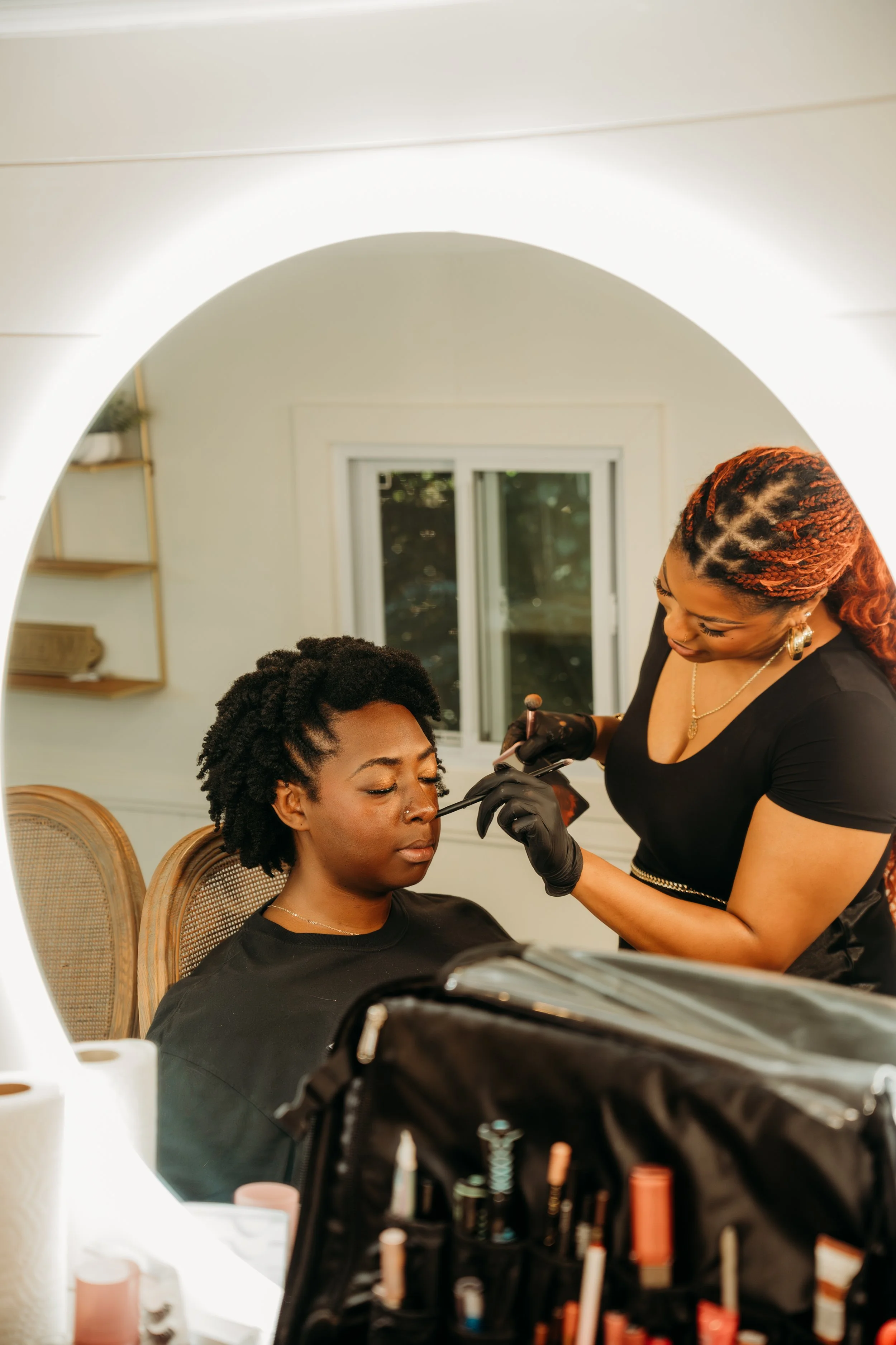 Kenya Beats Makeup Artistry applying soft glam makeup to a darkskin bride in Raleigh, NC. 