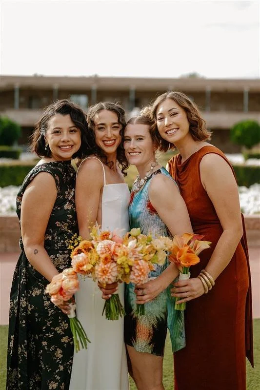 Image of a Bride and her 3 bridesmaids in bold spring florals and various dress colors. Photography By: Andrea Cakmar Photo + Film