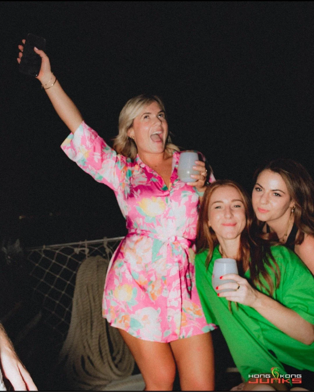 She said &ldquo;one drink&rdquo; and five minutes later she&rsquo;s the unofficial hype captain, rallying the whole deck with a cup in one hand and pure chaos in the other. Her friends just showed up to support the mission and somehow became part of 