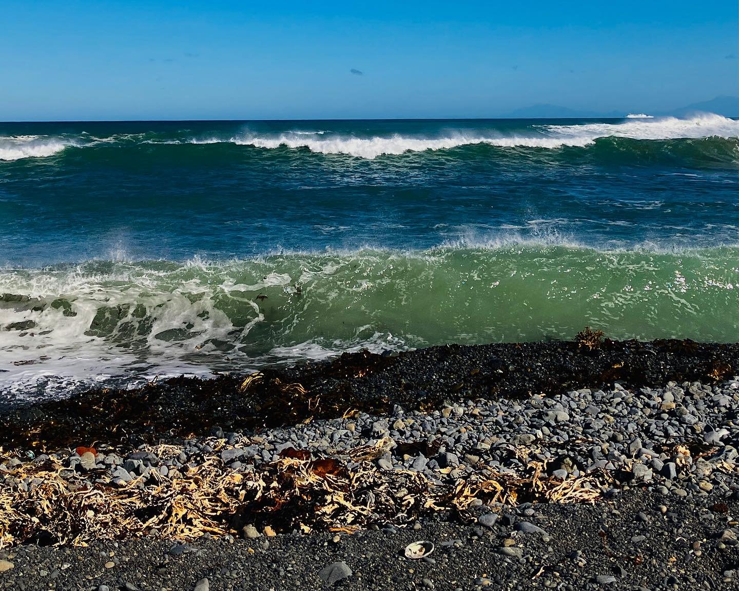 Huge swell at Ōwhiro Bay this morning looking toward Red Rocks. Everything sparkled, the wind was cold, the sea surging up onto the rocky beach. Exhilerating. I think these photos capture a little bit of the atmosphere. 

#beachphotography #coastalph