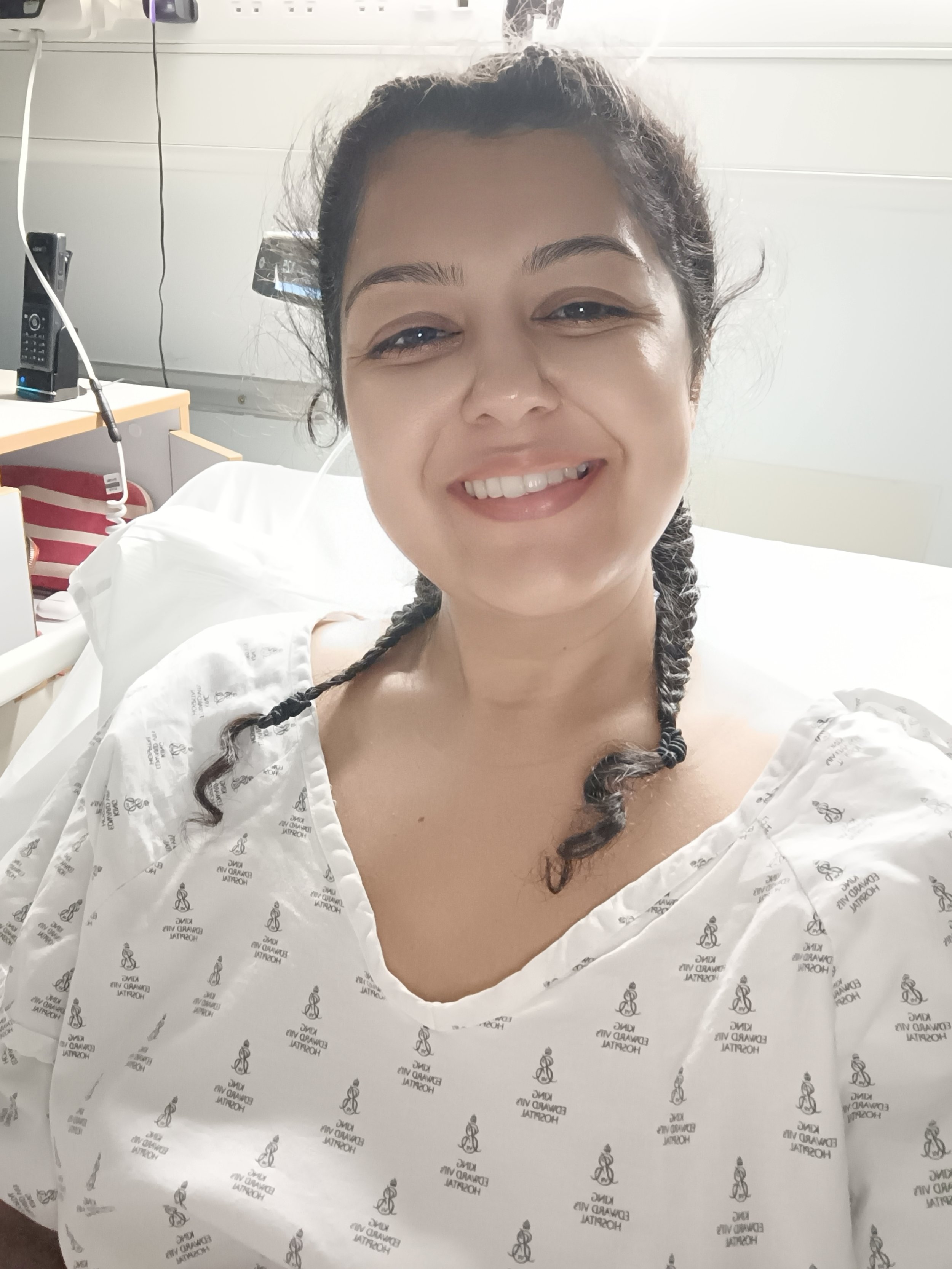 A photo of a lady in her hospital gown after surgery for endometriosis
