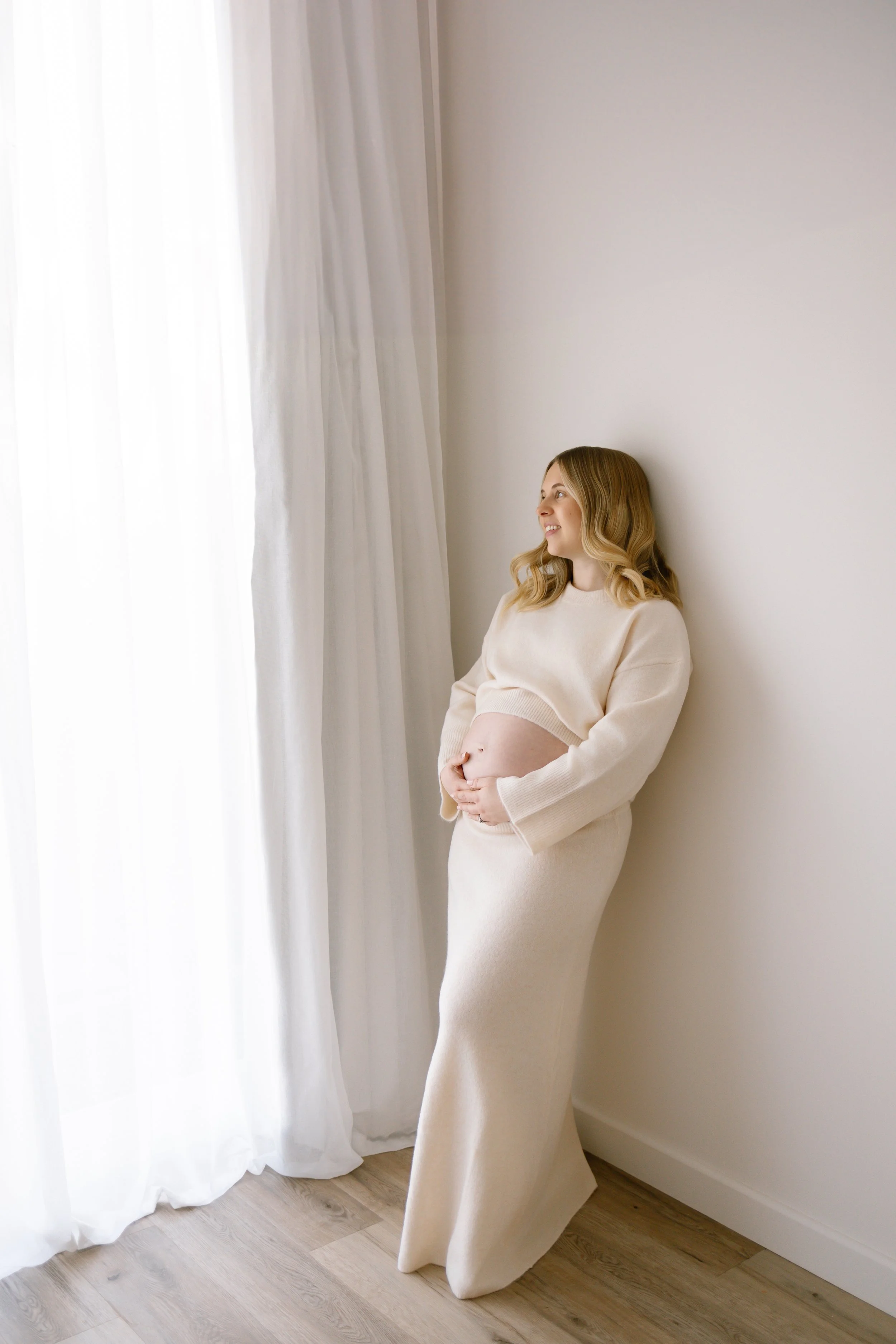 Pregnant woman rests during a maternity photoshoot in Salisbury studio
