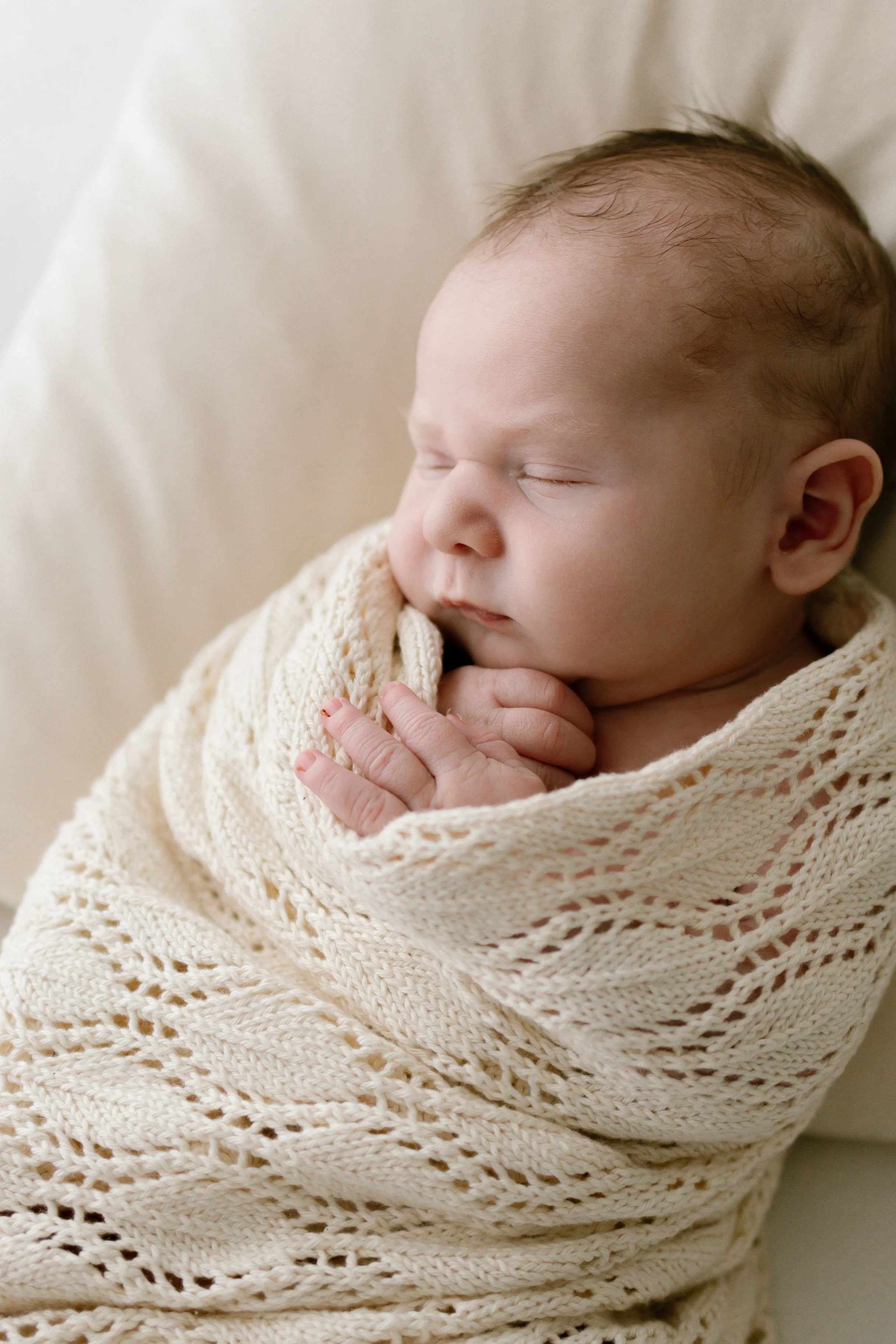 newborn baby sleeping in blanket