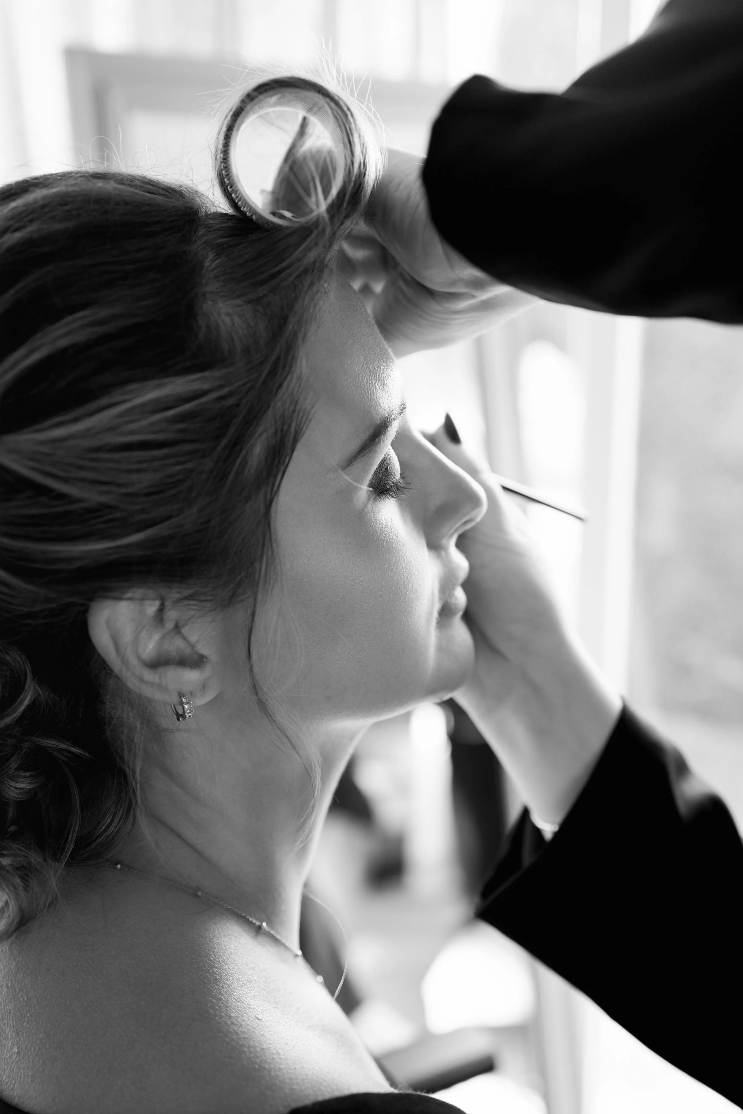 Bride on her wedding morning getting her makeup done