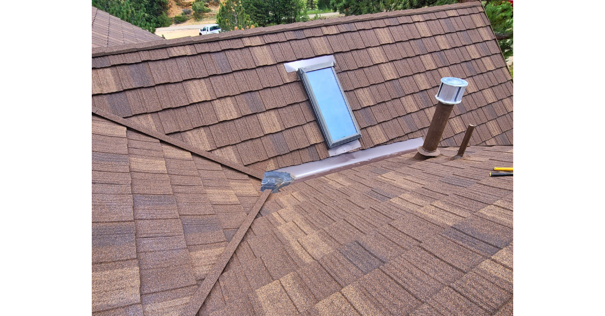 Roof skylight installation on asphalt shingle roofing system.