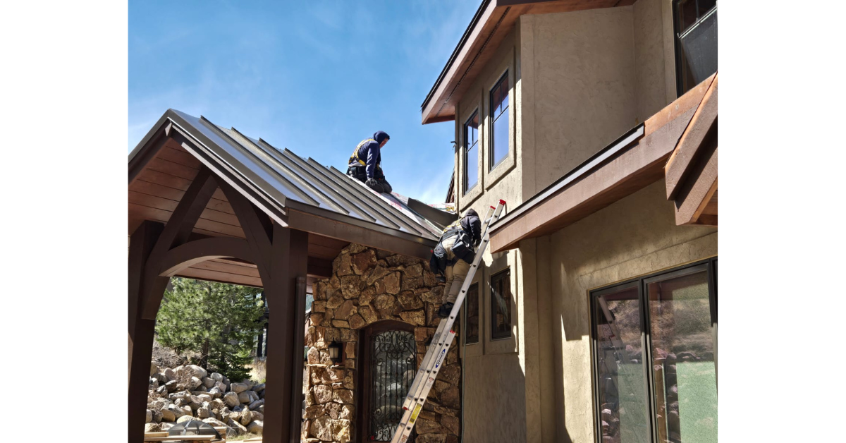 Roofing contractor installing a metal roof on a Colorado home.
