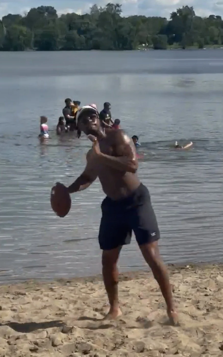 Austin Treadwell, DPT in Minneapolis, Minnesota at the beach loading up to throw a football