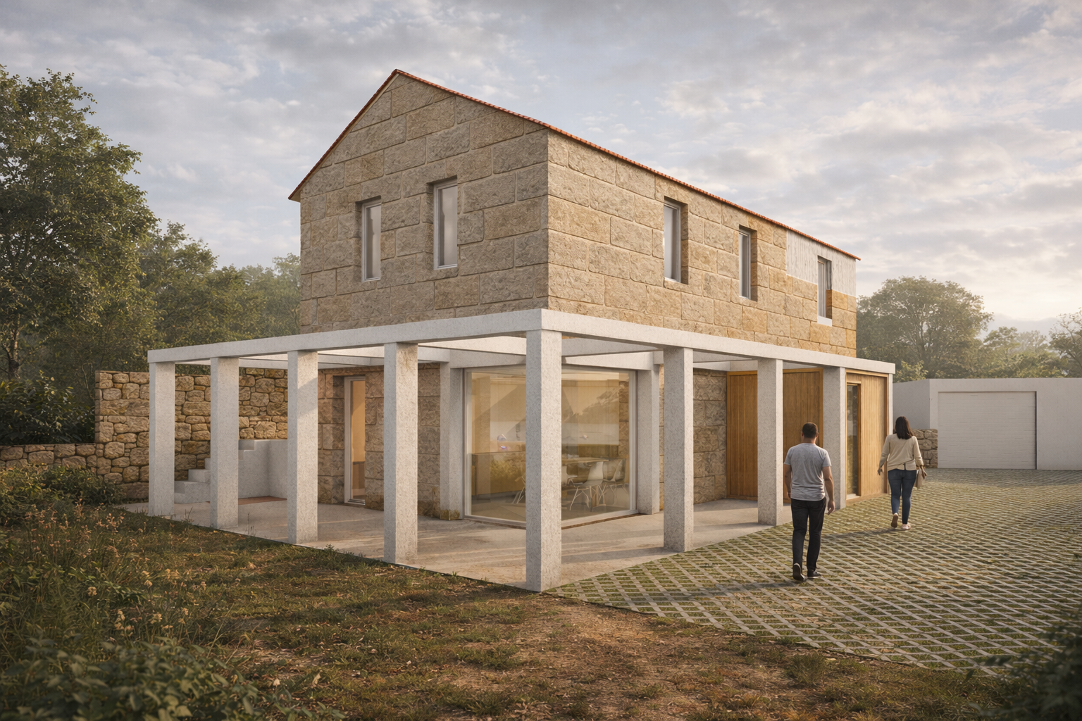 Vista exterior de vivienda rehabilitada en Nigrán (Pontevedra), con conservación de fachada de piedra, incorporación de pérgola ligera y apertura de huecos que mejoran la relación entre interior y exterior.