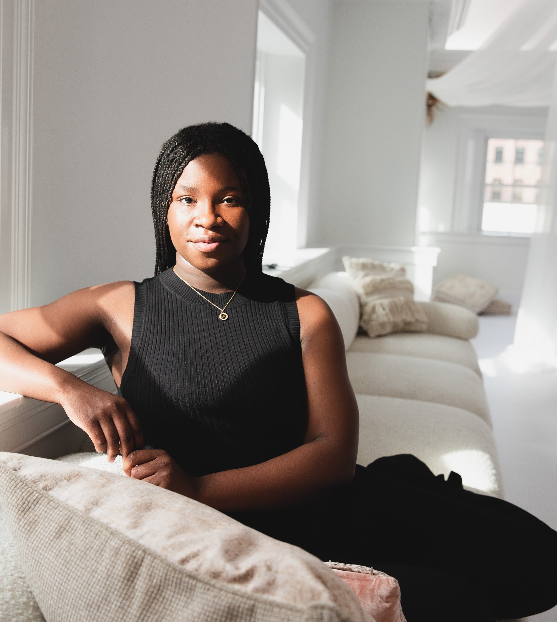 african-american-young-professional-headshot-white-couch.jpg