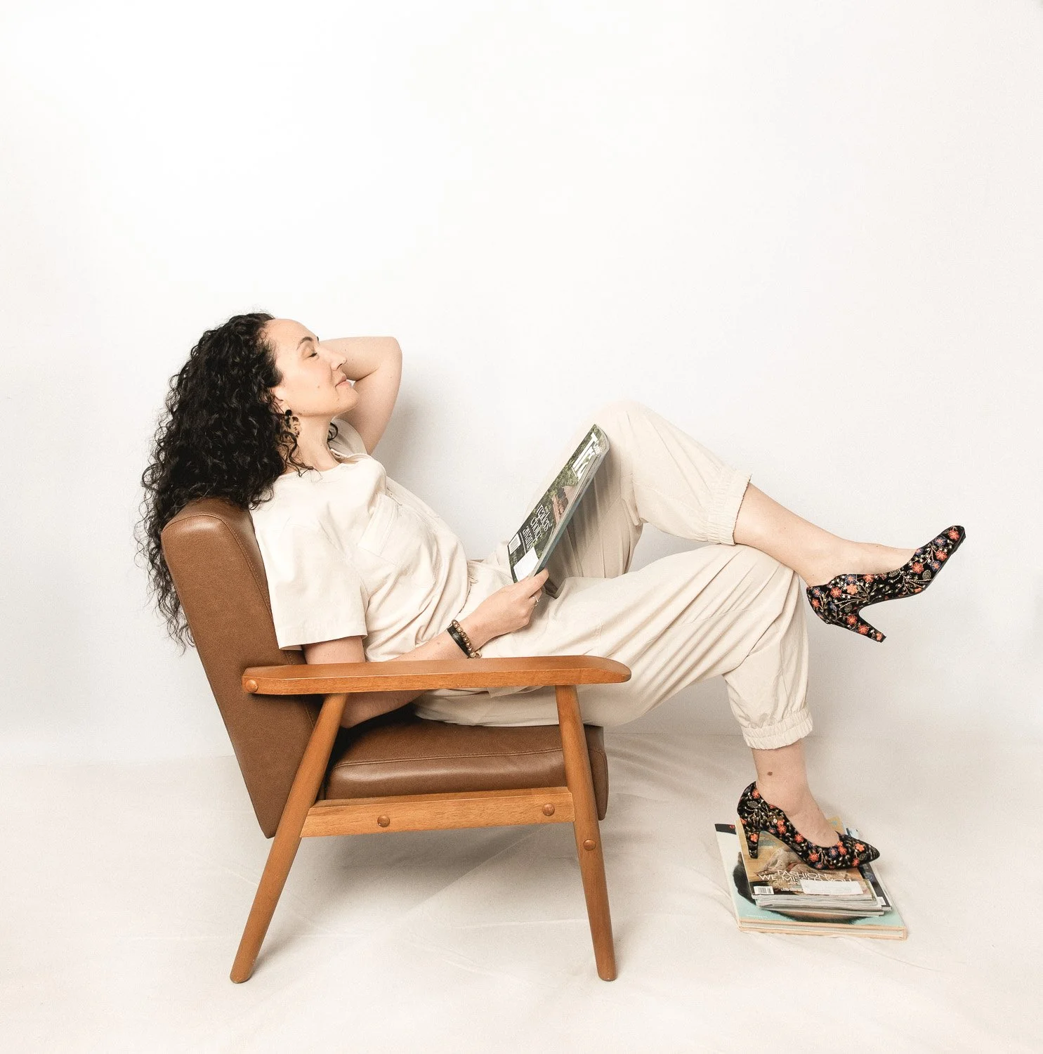 woman-sitting-in-chair-sideways-reading-magazines.jpg