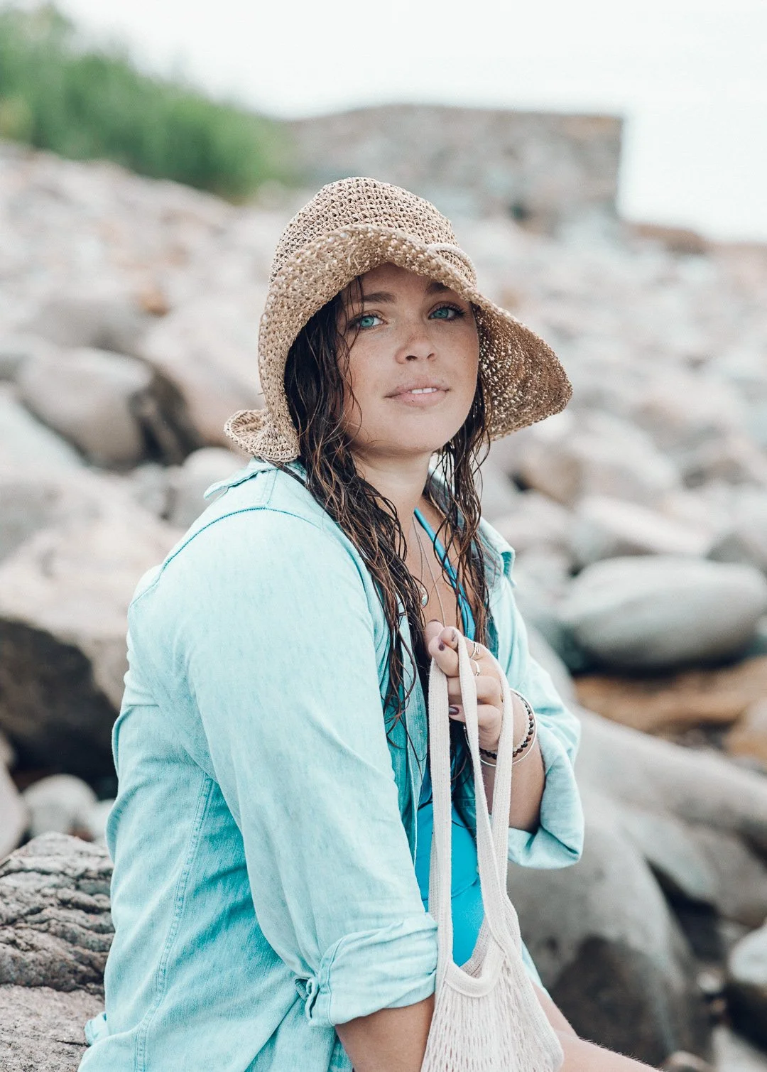 portrait-young-female-at-beach-sitting-on-rocks.jpg