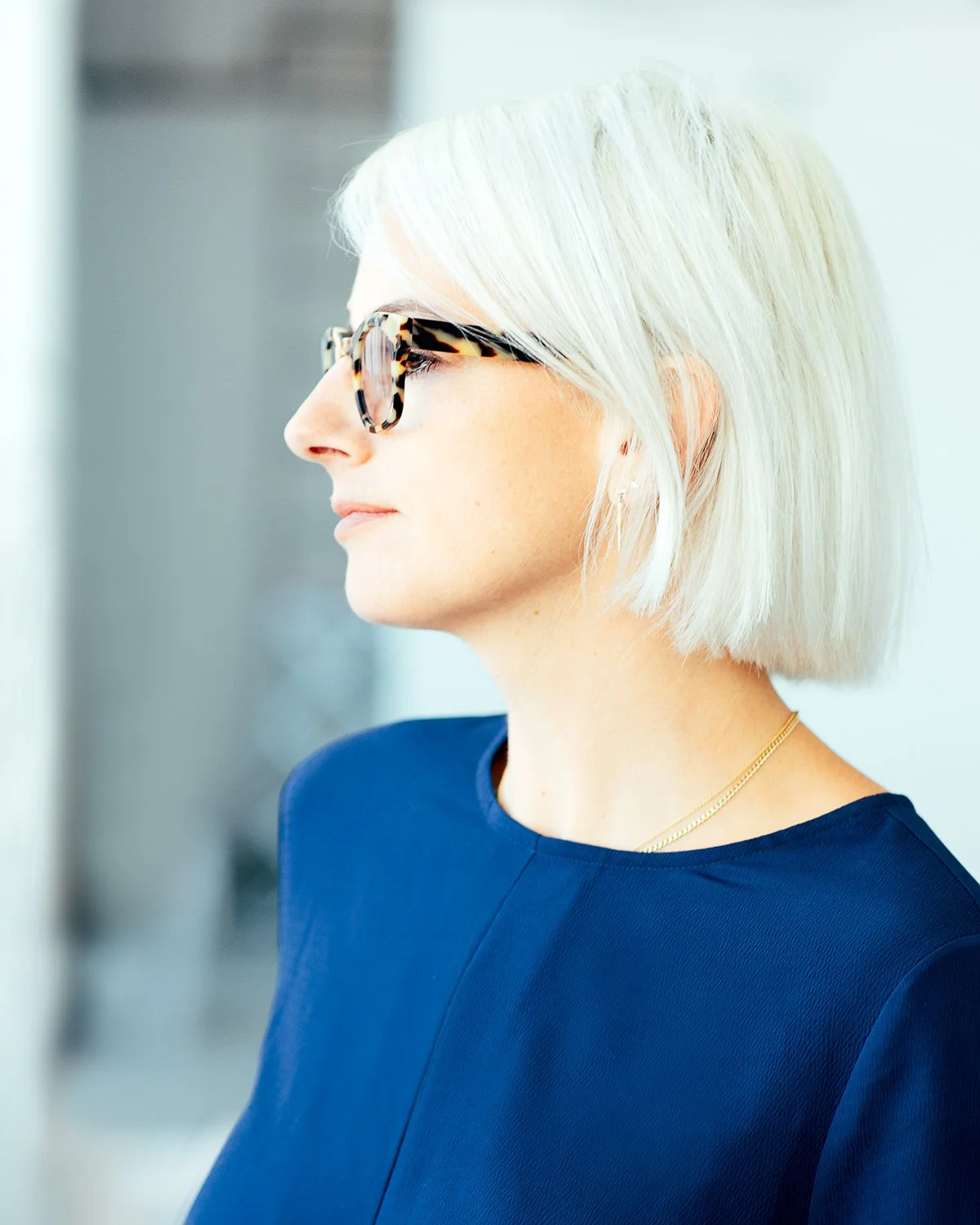 woman-blonde-hair-tortoise-shell-glasses-blue-shirt.jpg