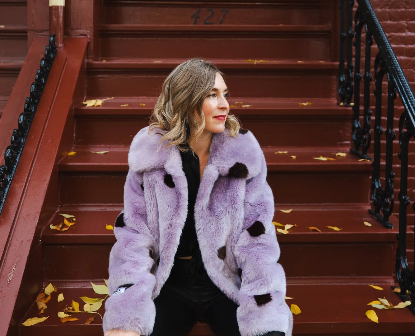woman-sitting-on-stoup-purple-jacket.jpg