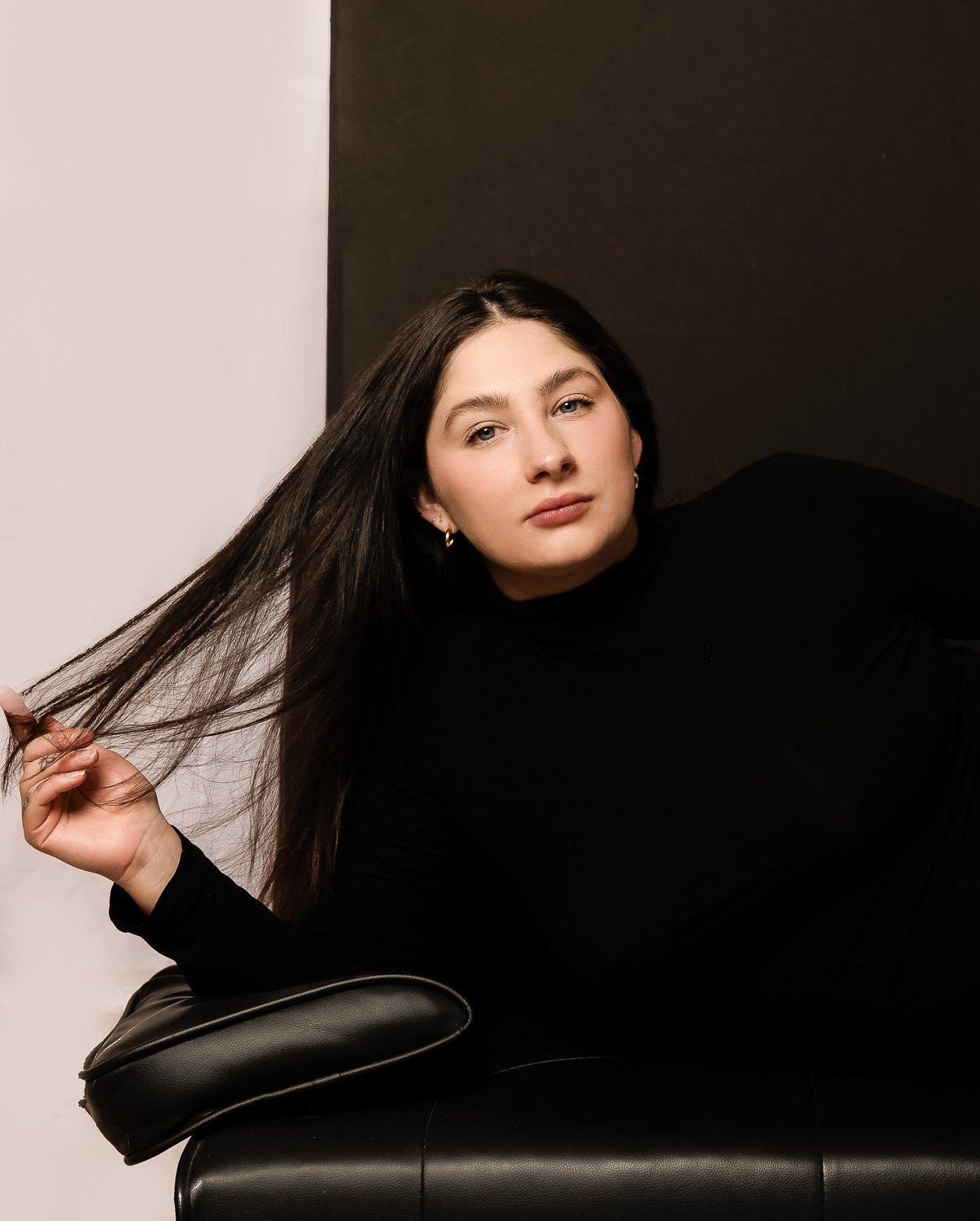 young-woman-portrait-long-hair-black-couch.jpg