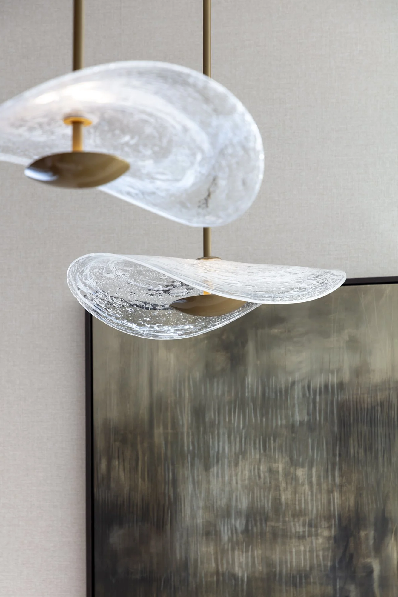 hand blown clear bubble pendant lights over a kitchen island for Nineteen Interiors