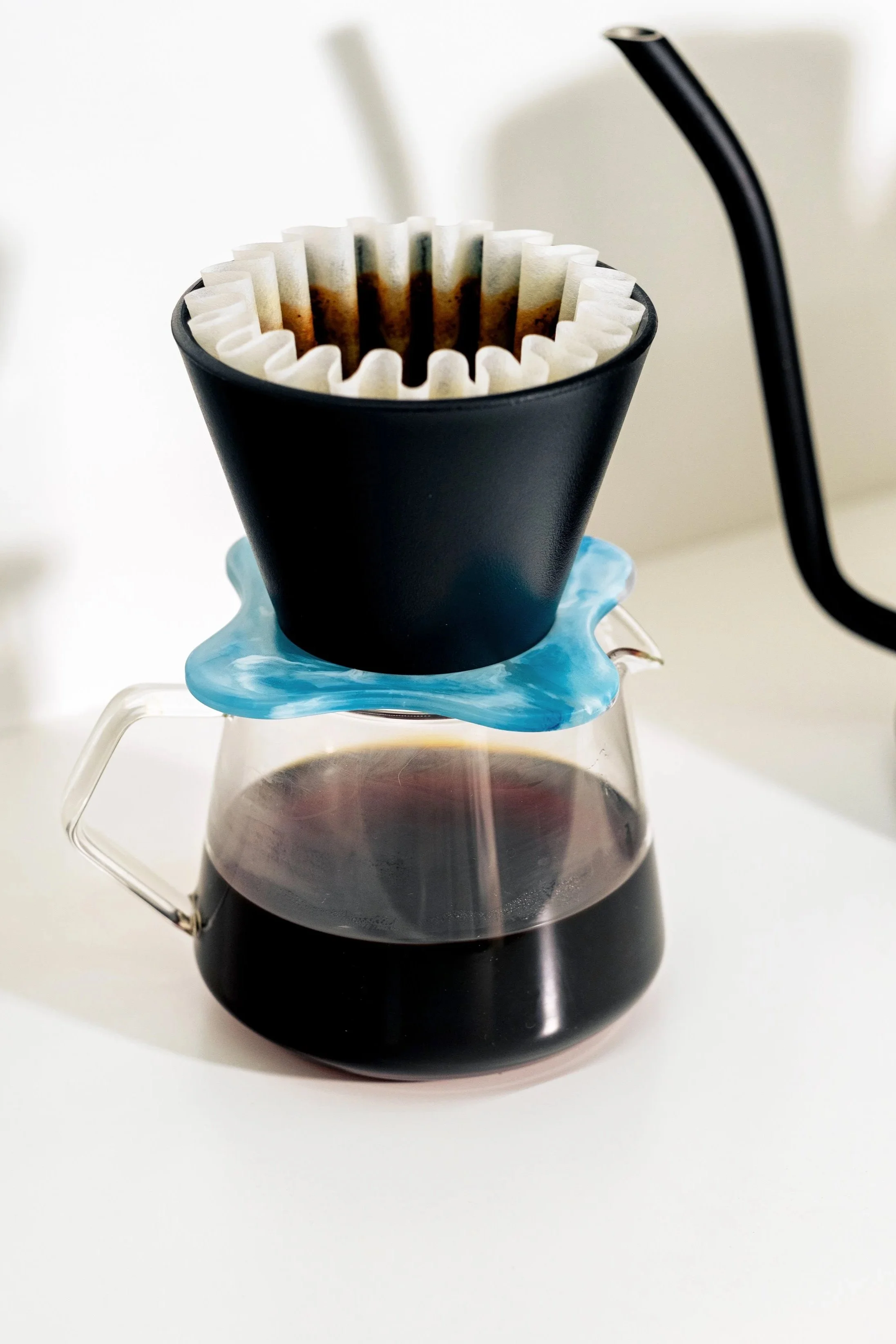Pour-over coffee brewing into a glass carafe