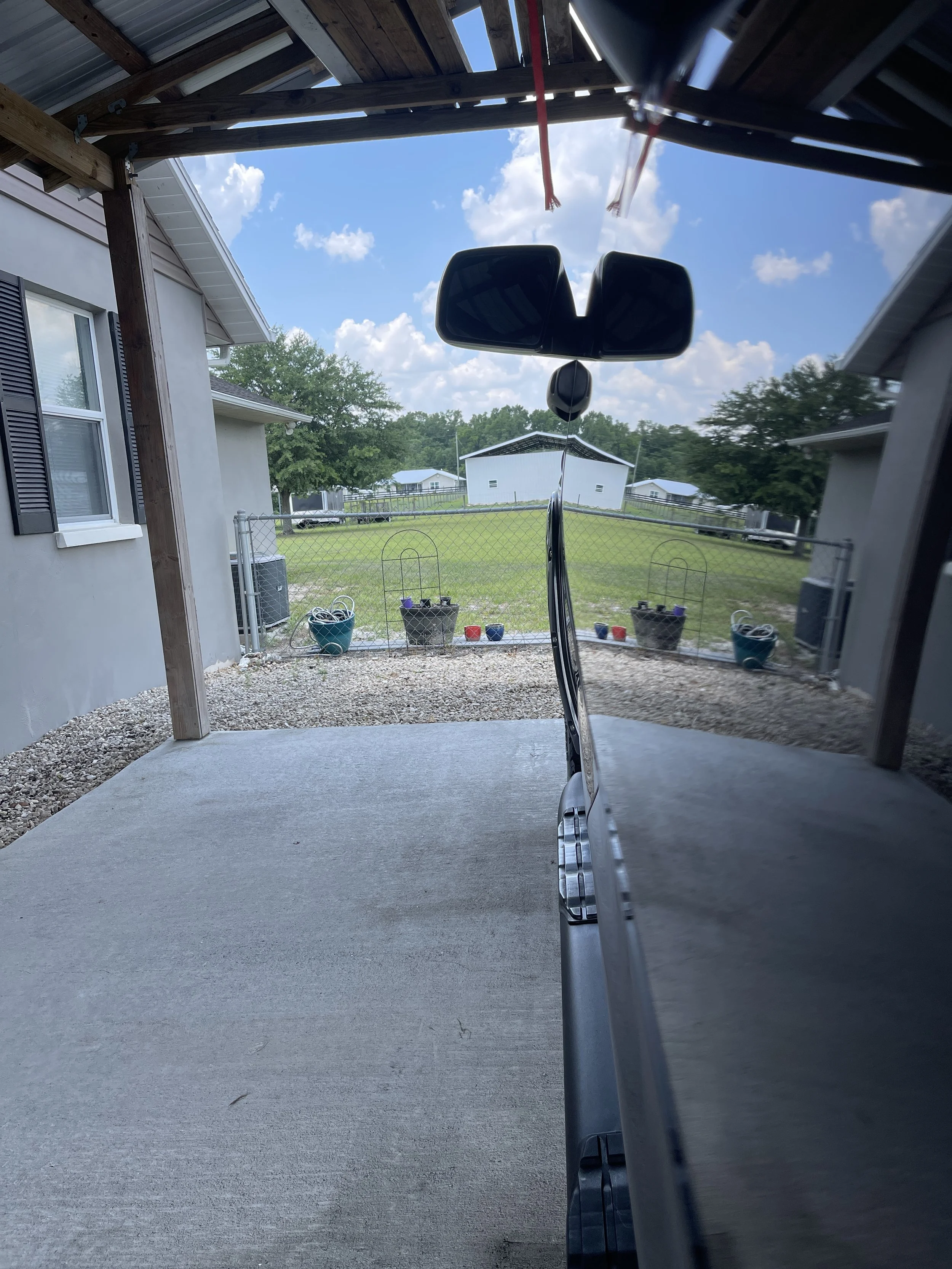 Gray truck mirror reflection a freshly detailed truck after professional polishing and paint protection.