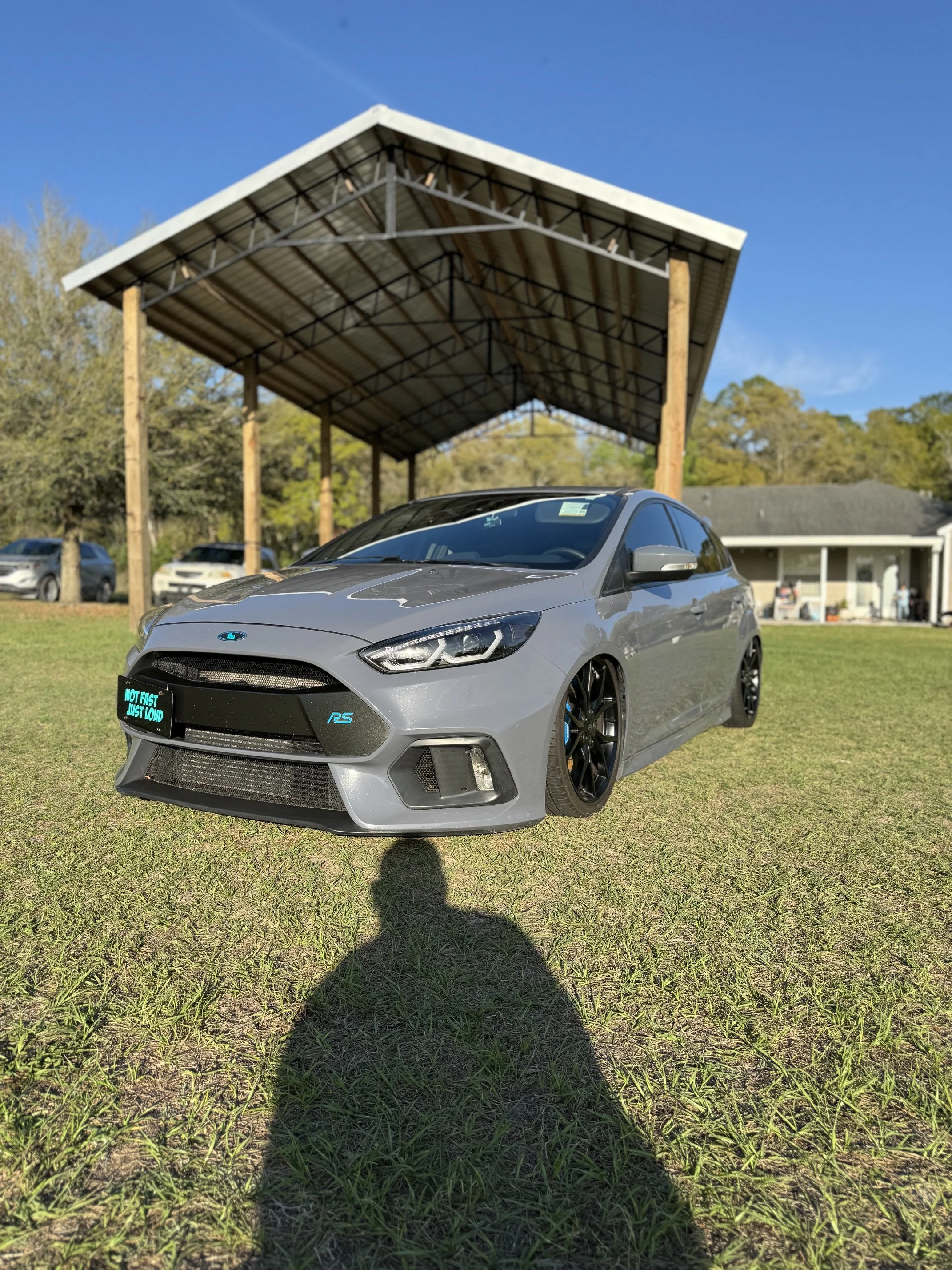 Silver sports car protected with a professional ceramic coating under a covered detail studio in North Central Florida.