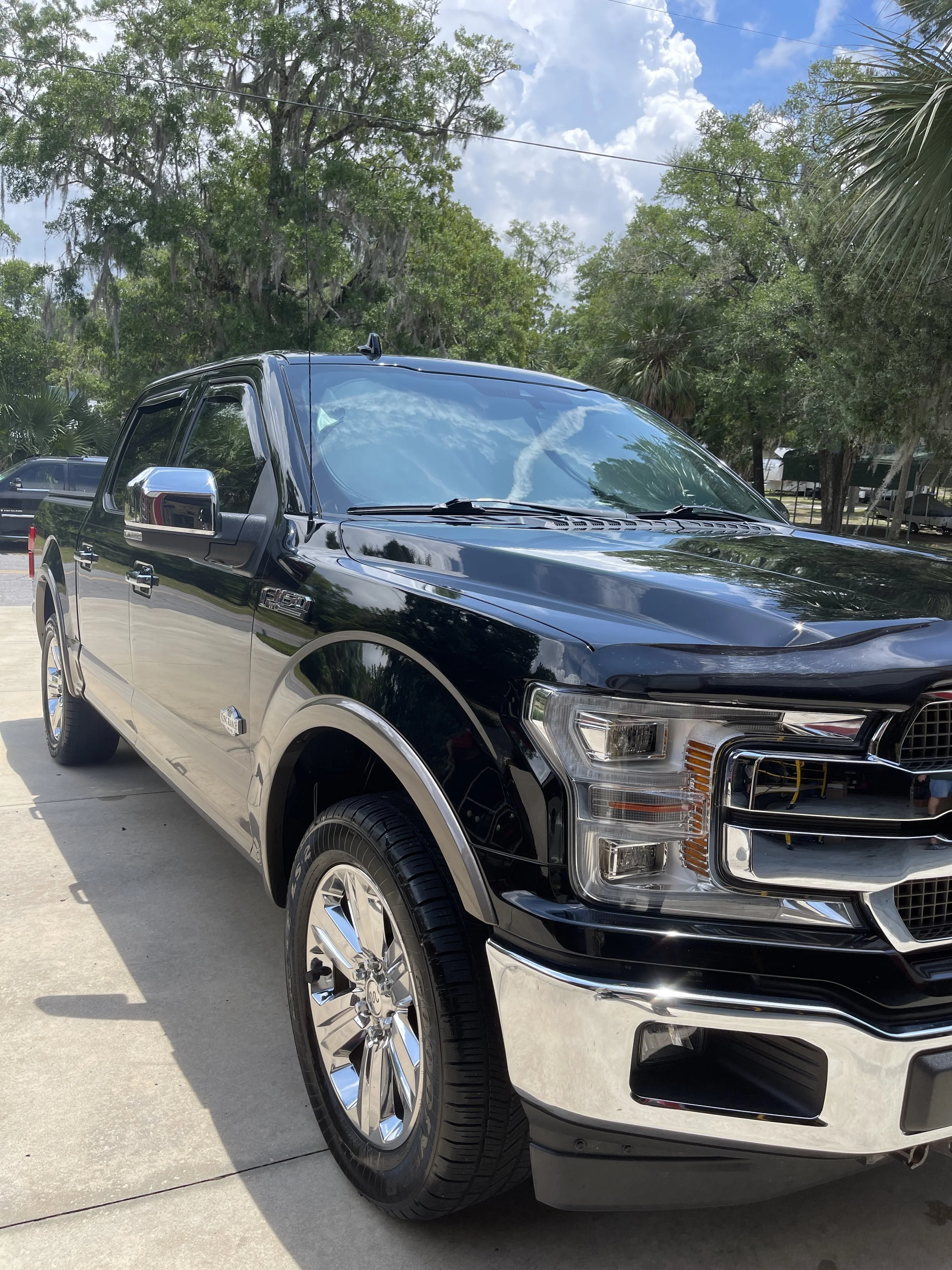 A black pickup truck after a professional detail that has been ceramic coated.