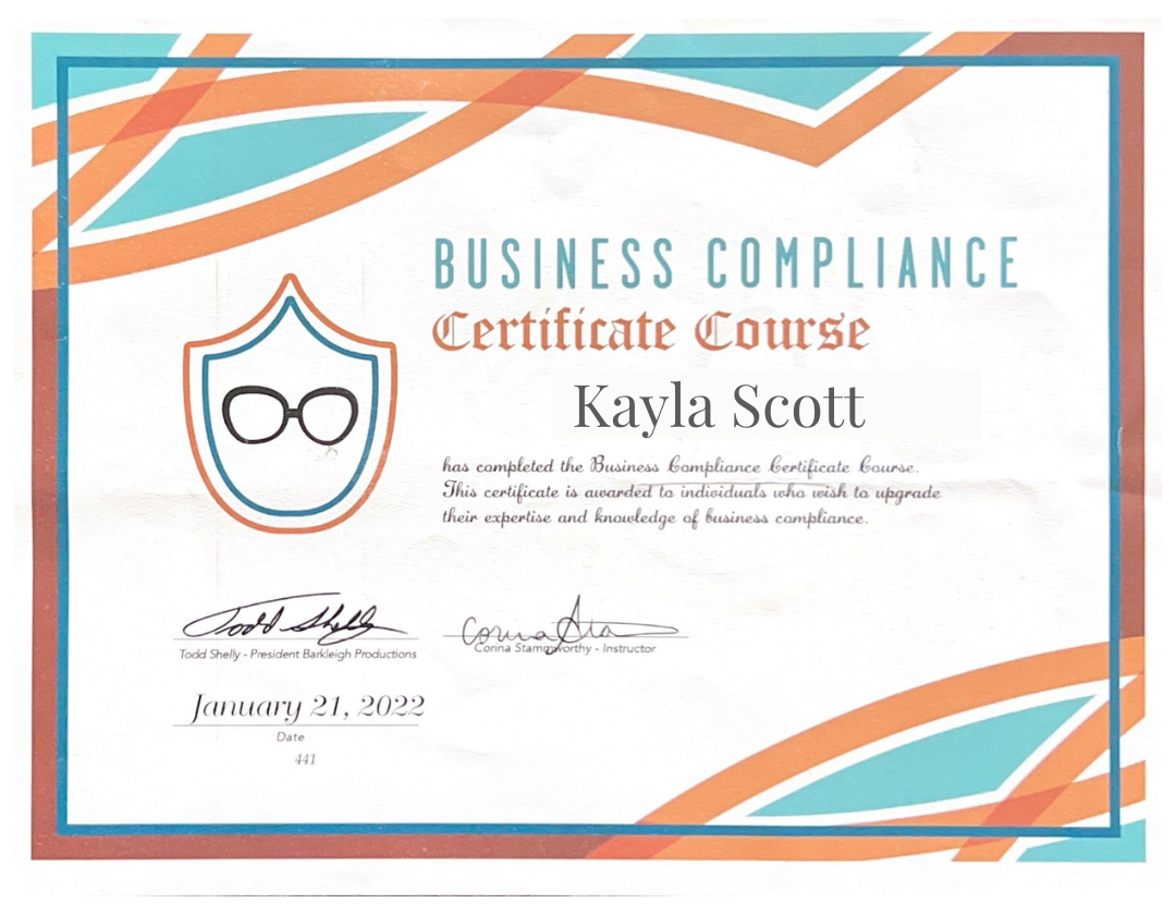 Business compliance certificate awarded to Kayla Scott, featuring a shield emblem with glasses icon, signatures, and date January 21, 2022.