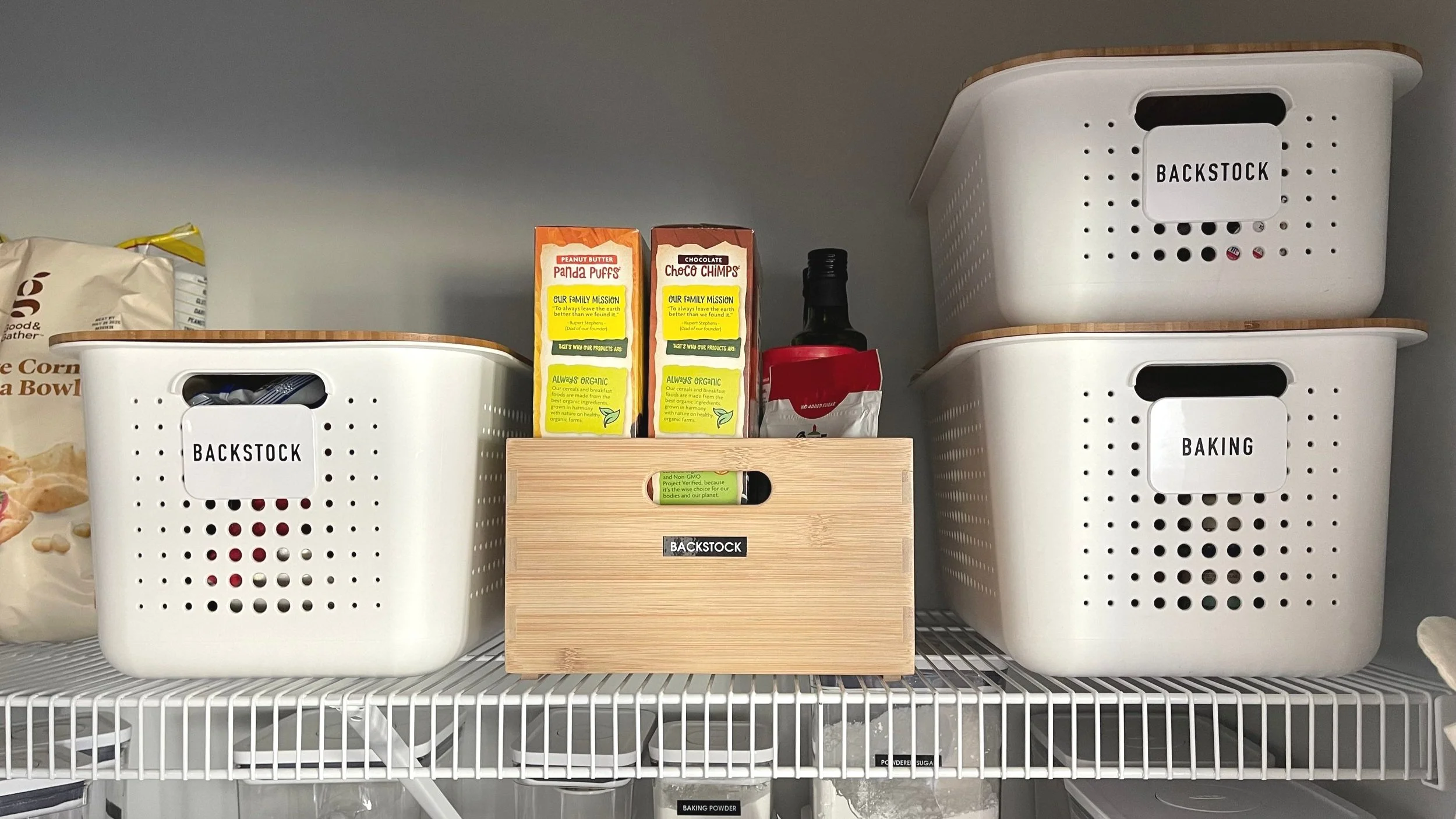 Organized pantry with labeled bins for storing extra pantry items and bulk grocery purchases.