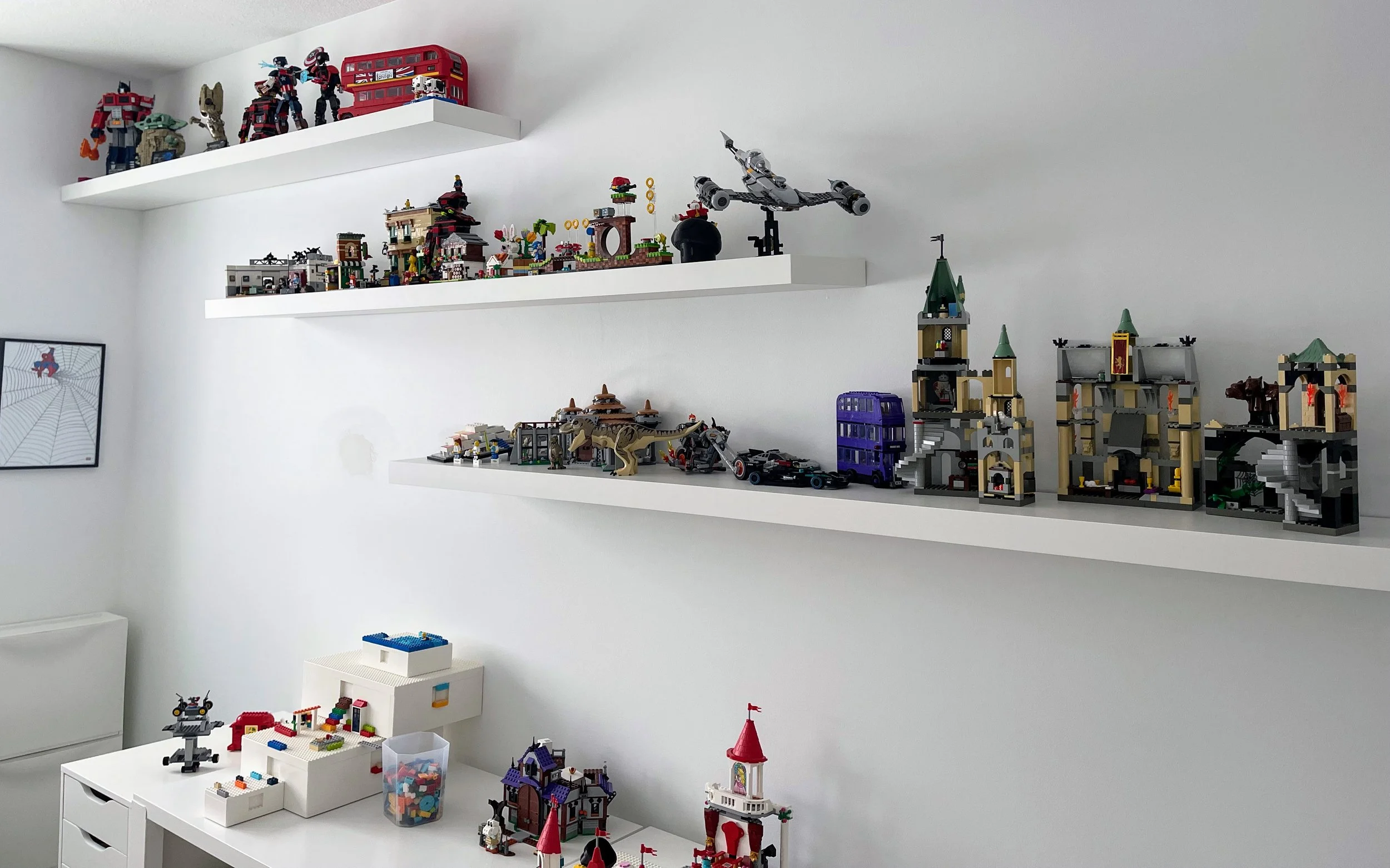 Finished LEGO sets displayed on IKEA LACK wall shelves to keep creations organized and off the floor.