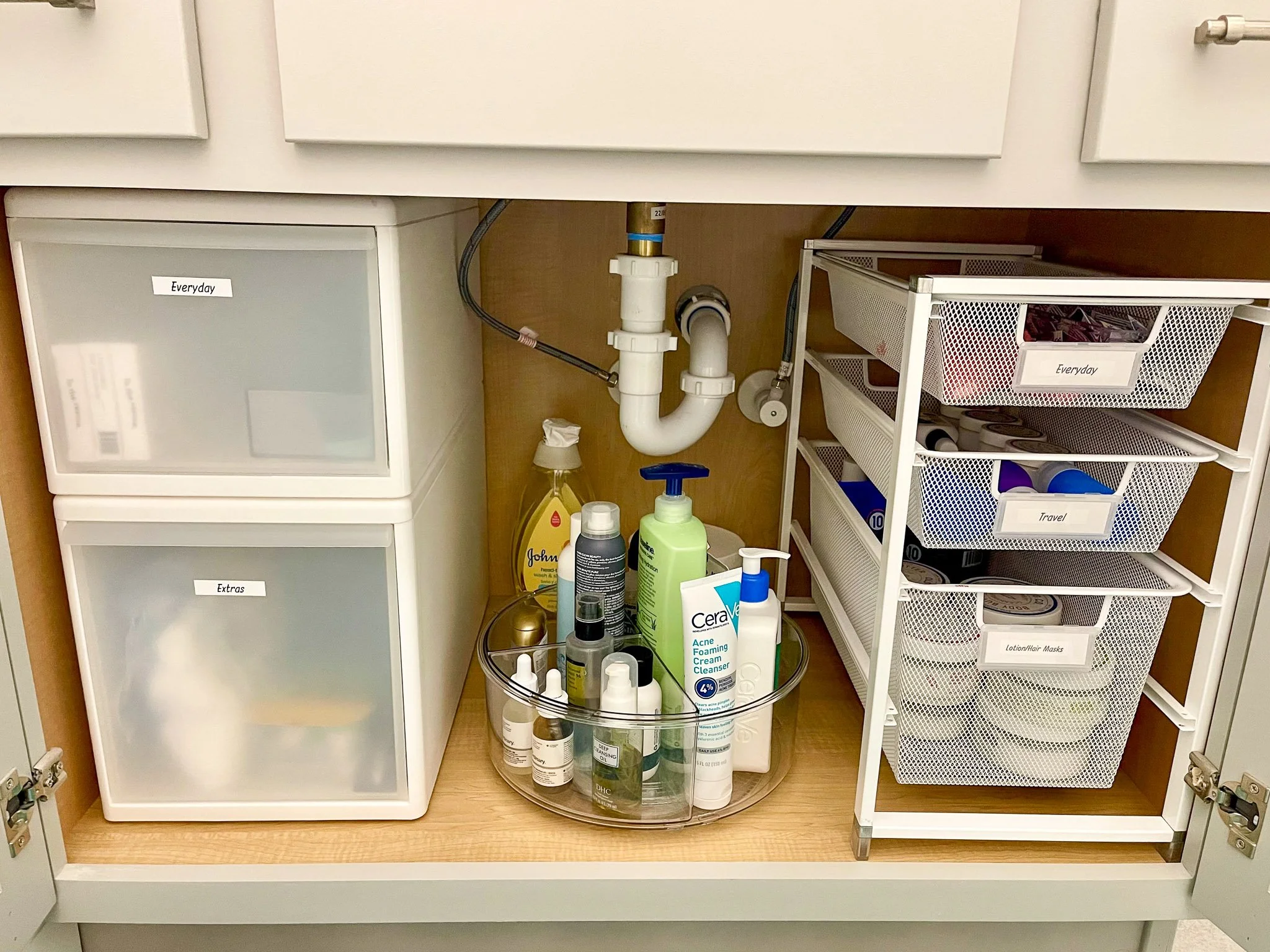 Bathroom undersink storage organized with a functional system