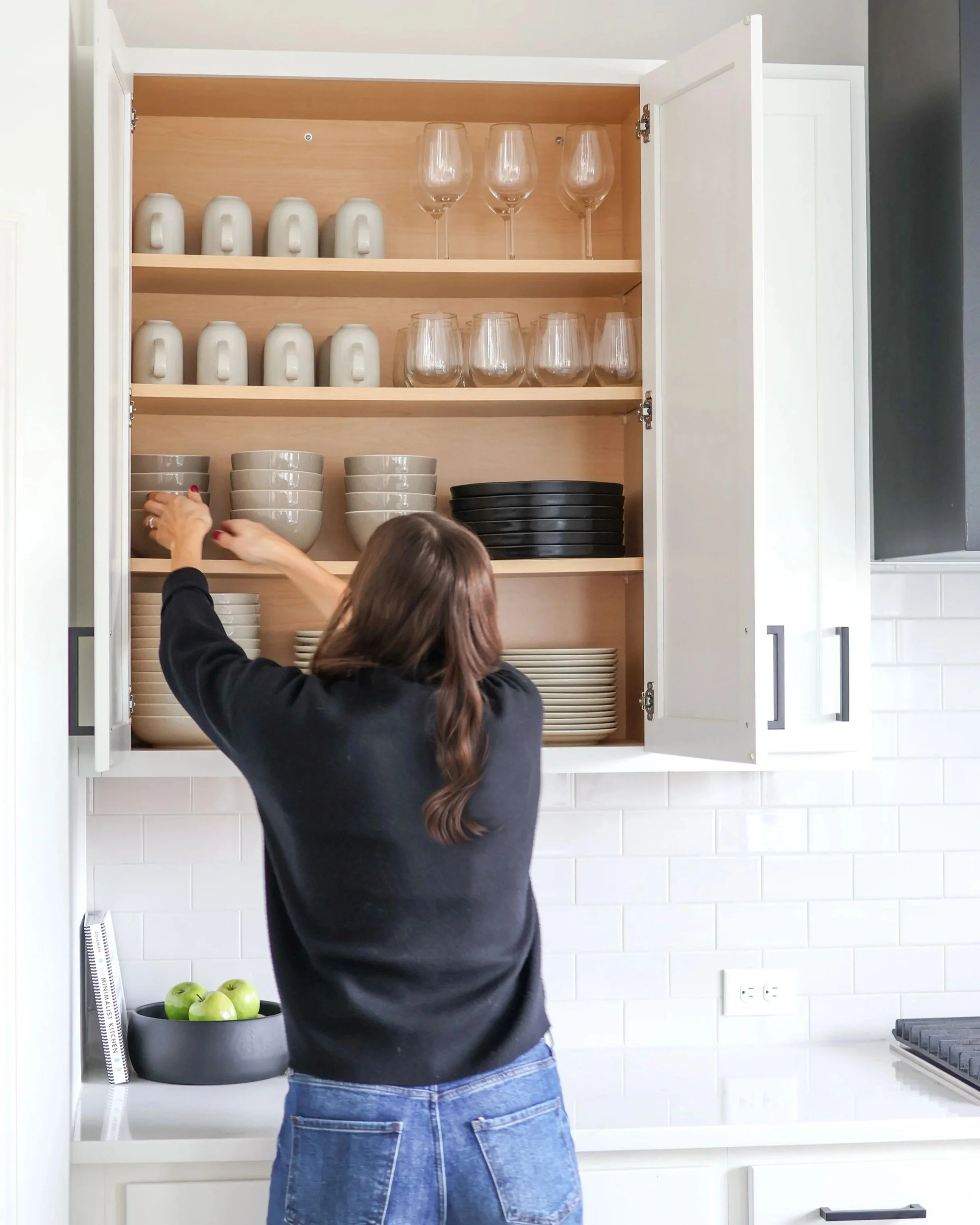 Professional home organizer creating customized kitchen organizing systems in a Twin Cities home.