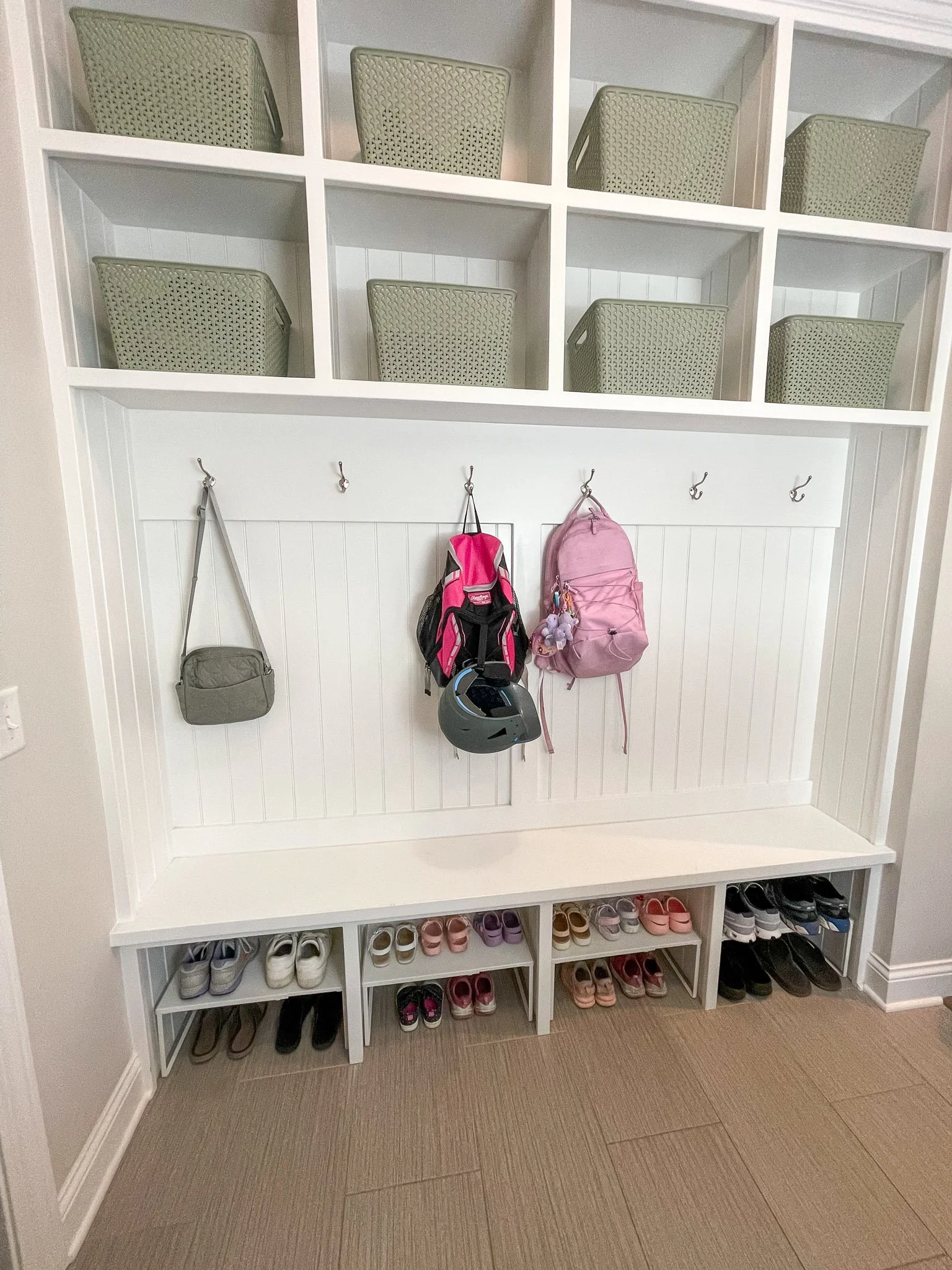 Organized family mudroom with storage for shoes and backpacks
